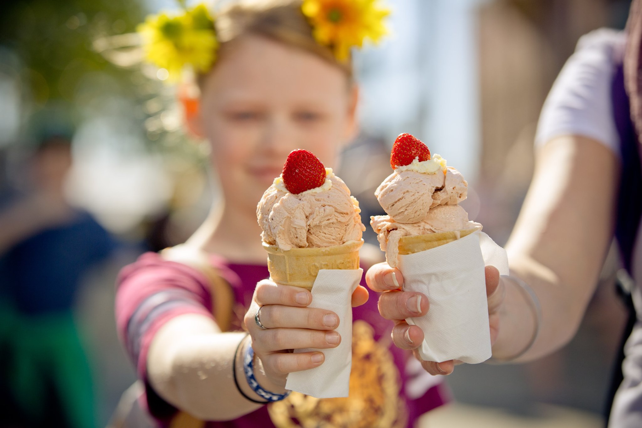 Young girl holds a strawberry sundae at The Ekka in Brisbane Young girl holds a strawberry sundae at The Ekka in Brisbane