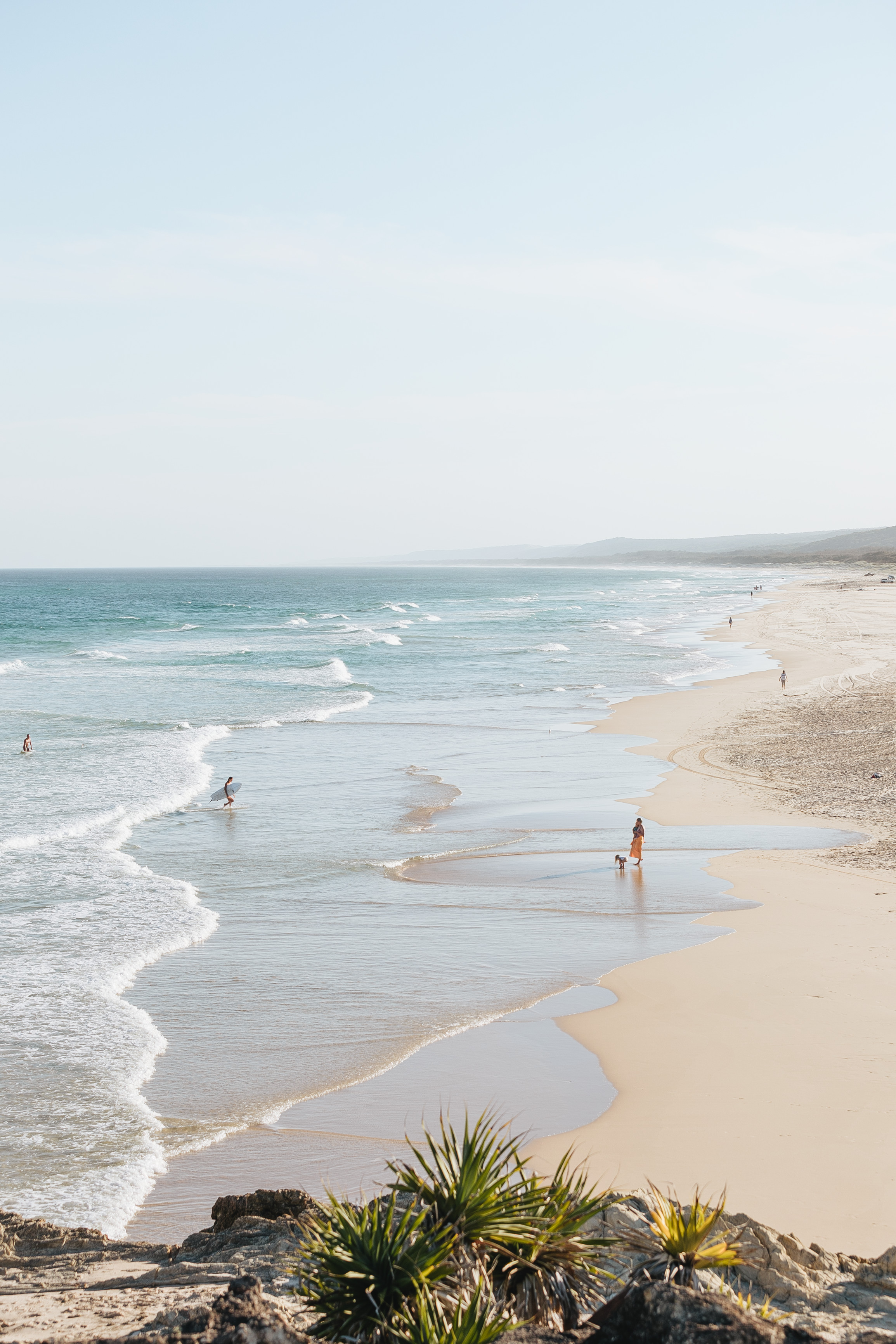 View looking down the beach with surfers and walkers at Main Beach, North Stradbroke Island | Solo travel Brisbane View looking down the beach with surfers and walkers at Main Beach, North Stradbroke Island | Solo travel Brisbane