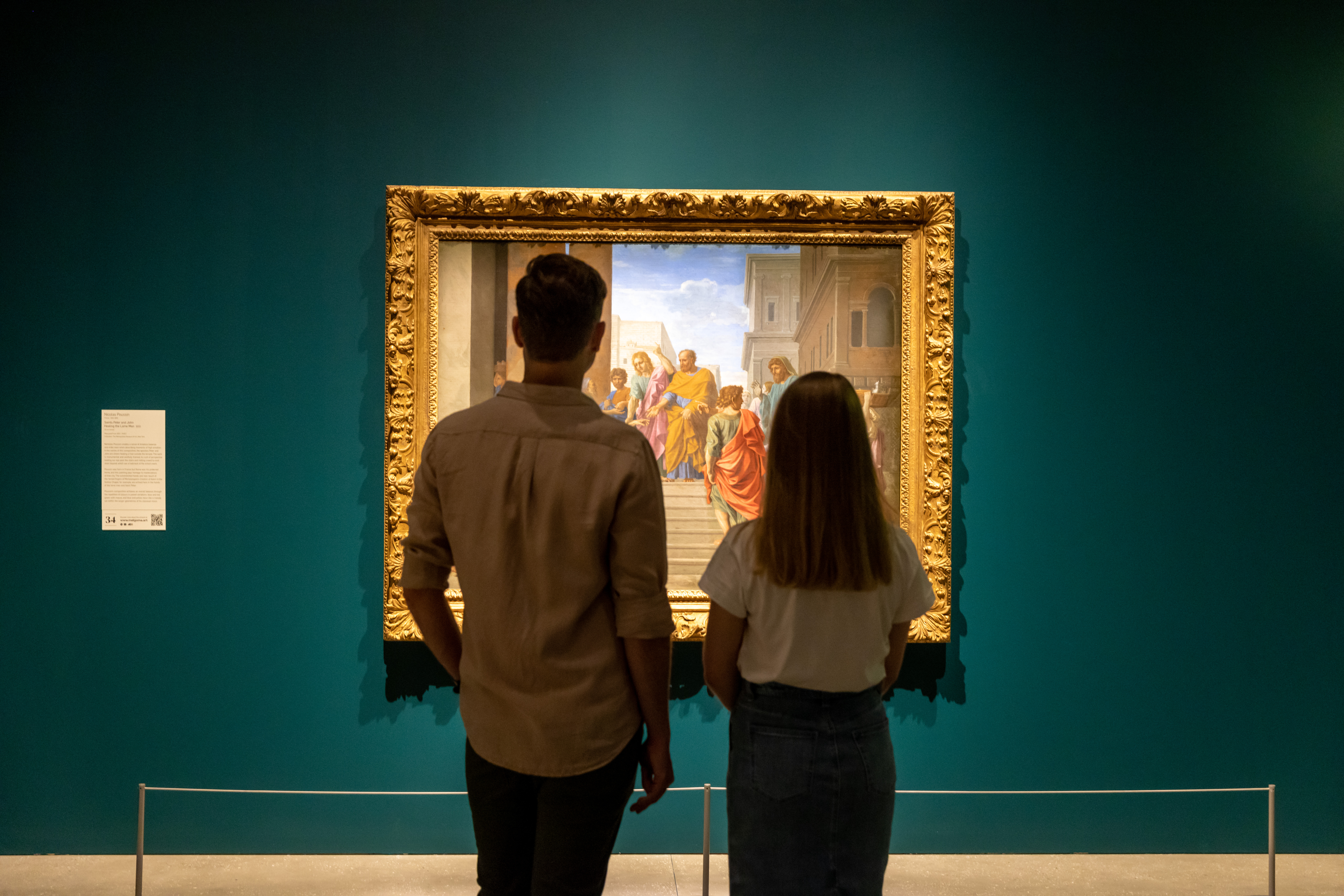 Couple looking at a Nicolas Poussin painting, which is part of the European Masterpieces exhibition