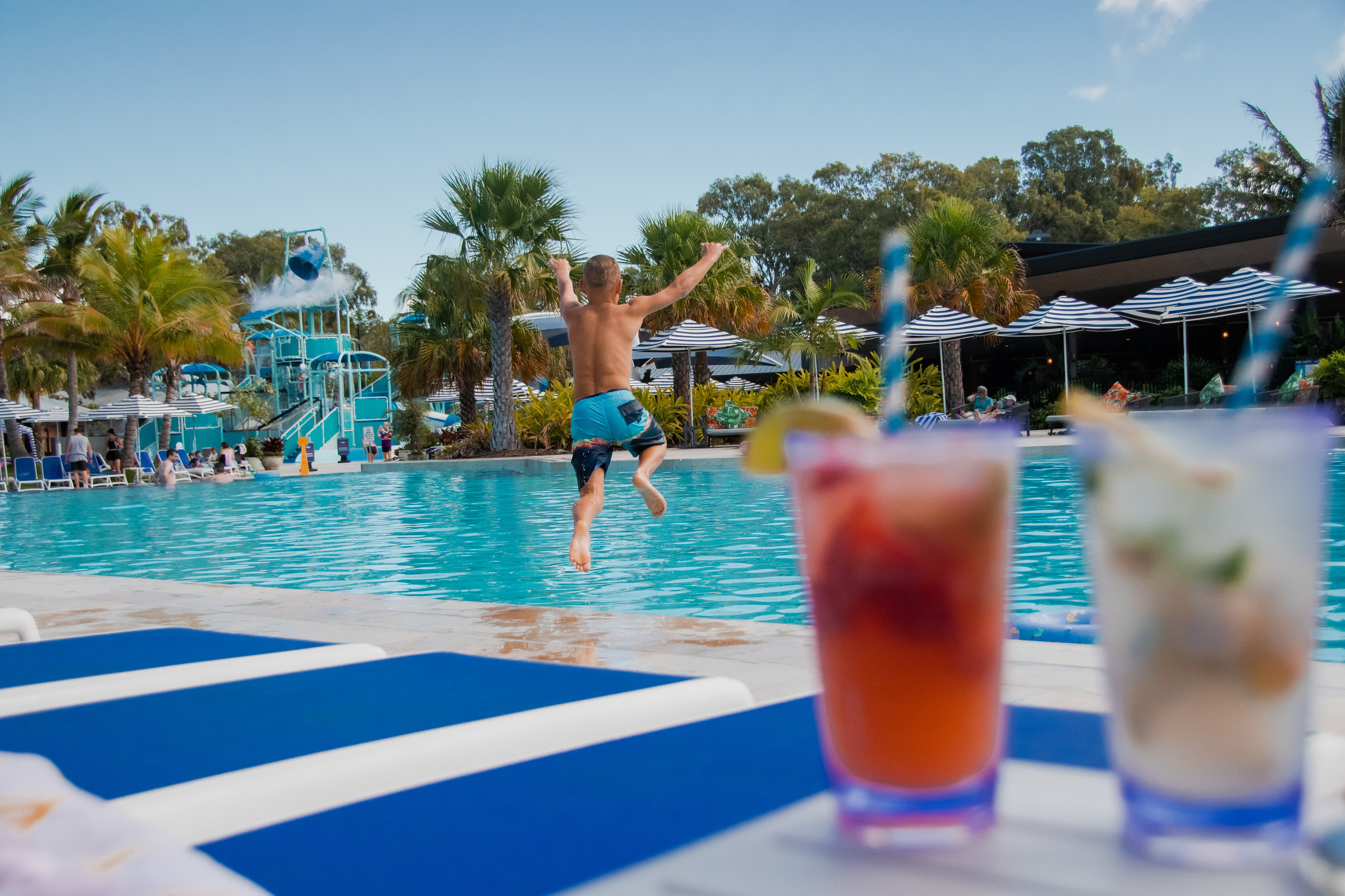Boy jumps in the pool at Big4 Sandstone Point Holiday Resort Boy jumps in the pool at Big4 Sandstone Point Holiday Resort