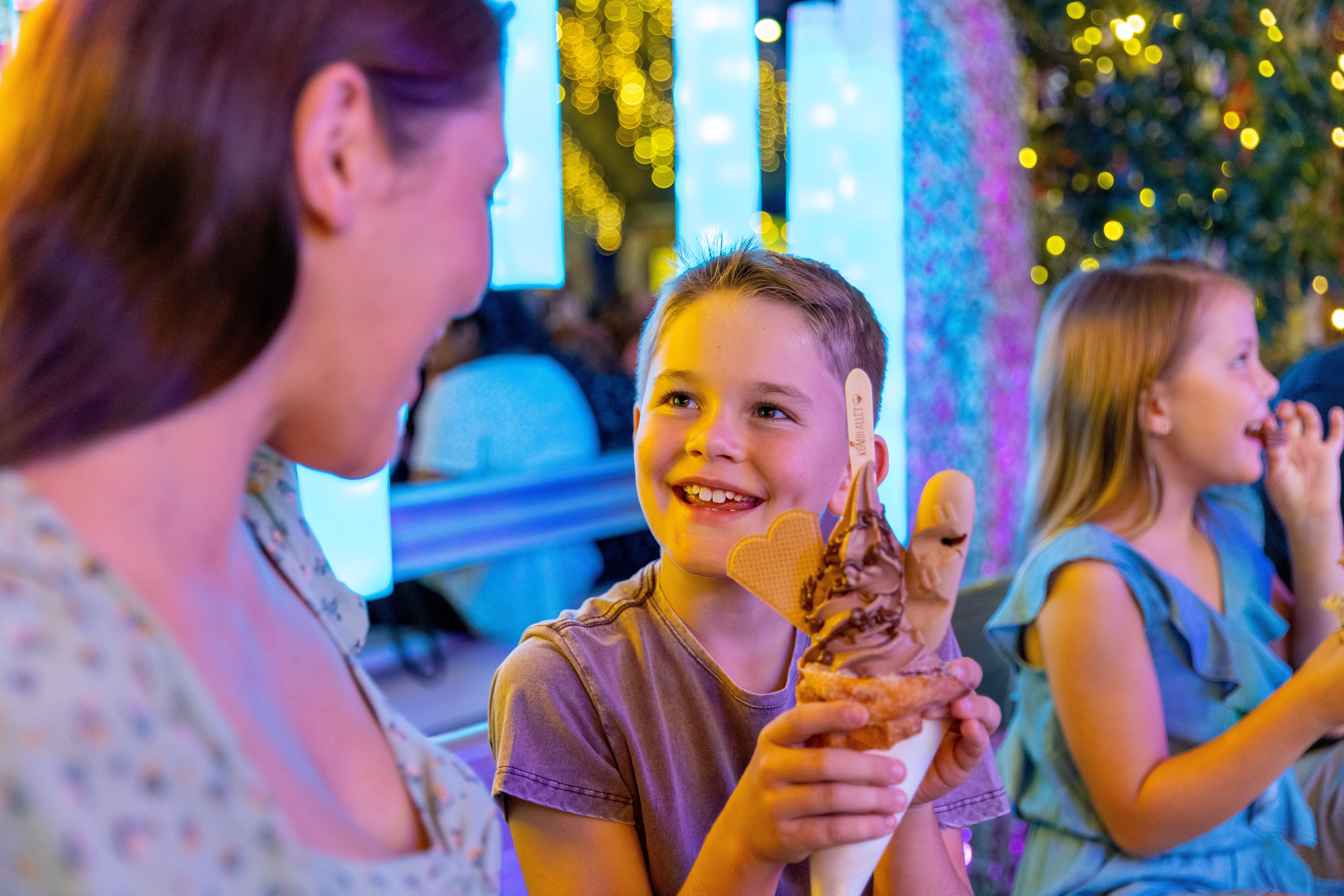 Mother and son enjoy a loaded doughnut ice cream at Eat Street Northshore Mother and son enjoy a loaded doughnut ice cream at Eat Street Northshore
