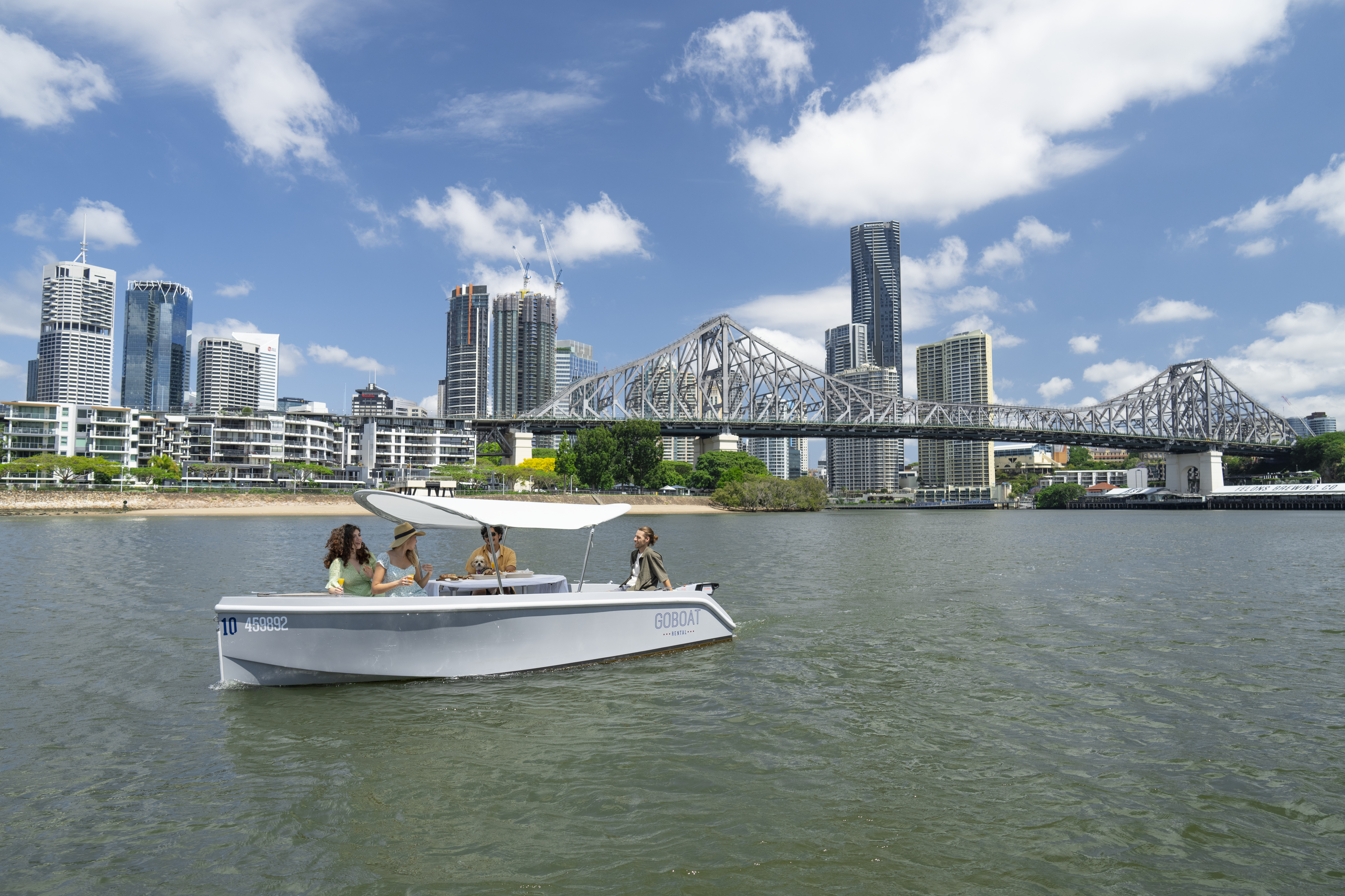 A group of friends on a boat on the Brisbane River A group of friends on a boat on the Brisbane River