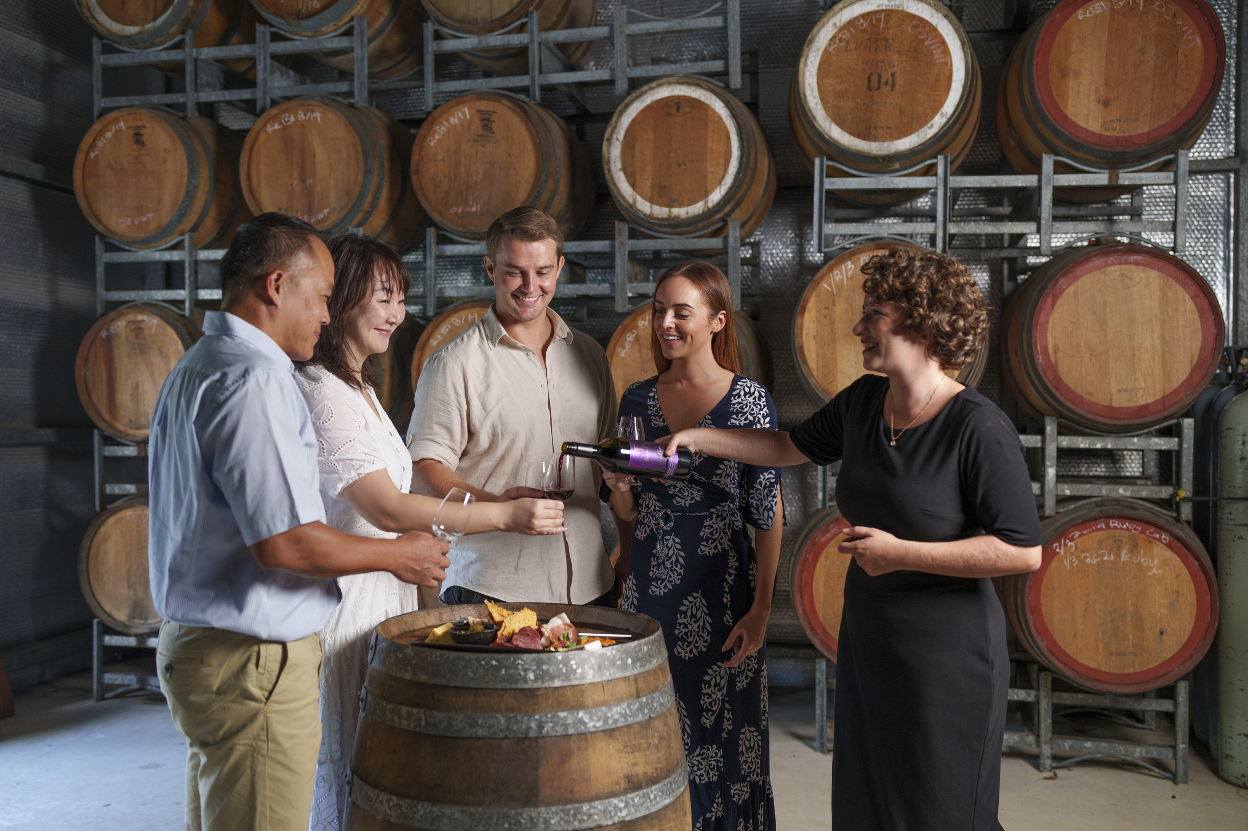 A group of friends wine tasting in the cellar door