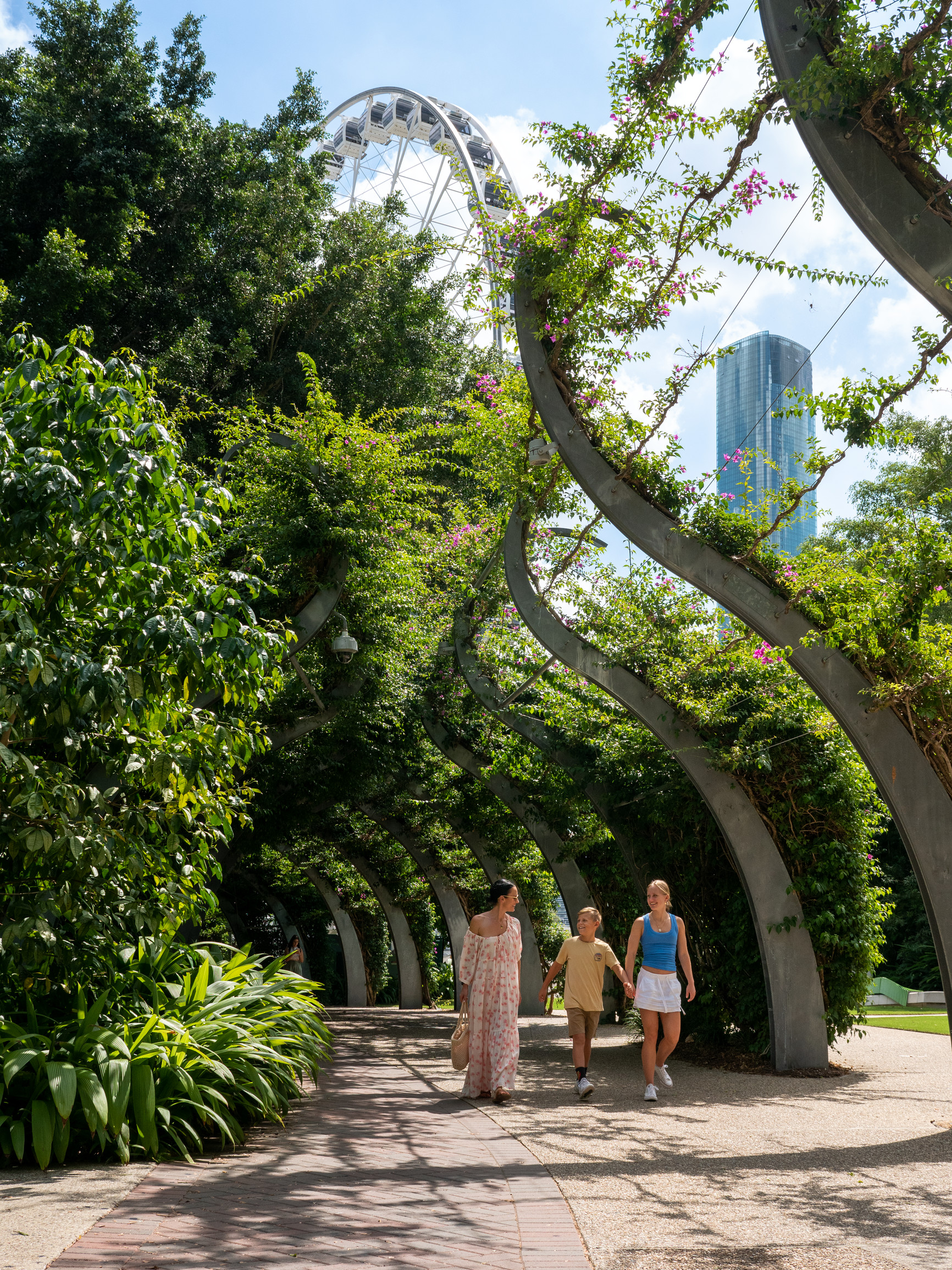 Family walking through the South Bank Parklands, with the bougainvillea in bloom | Five day Brisbane Gold Coast family holiday