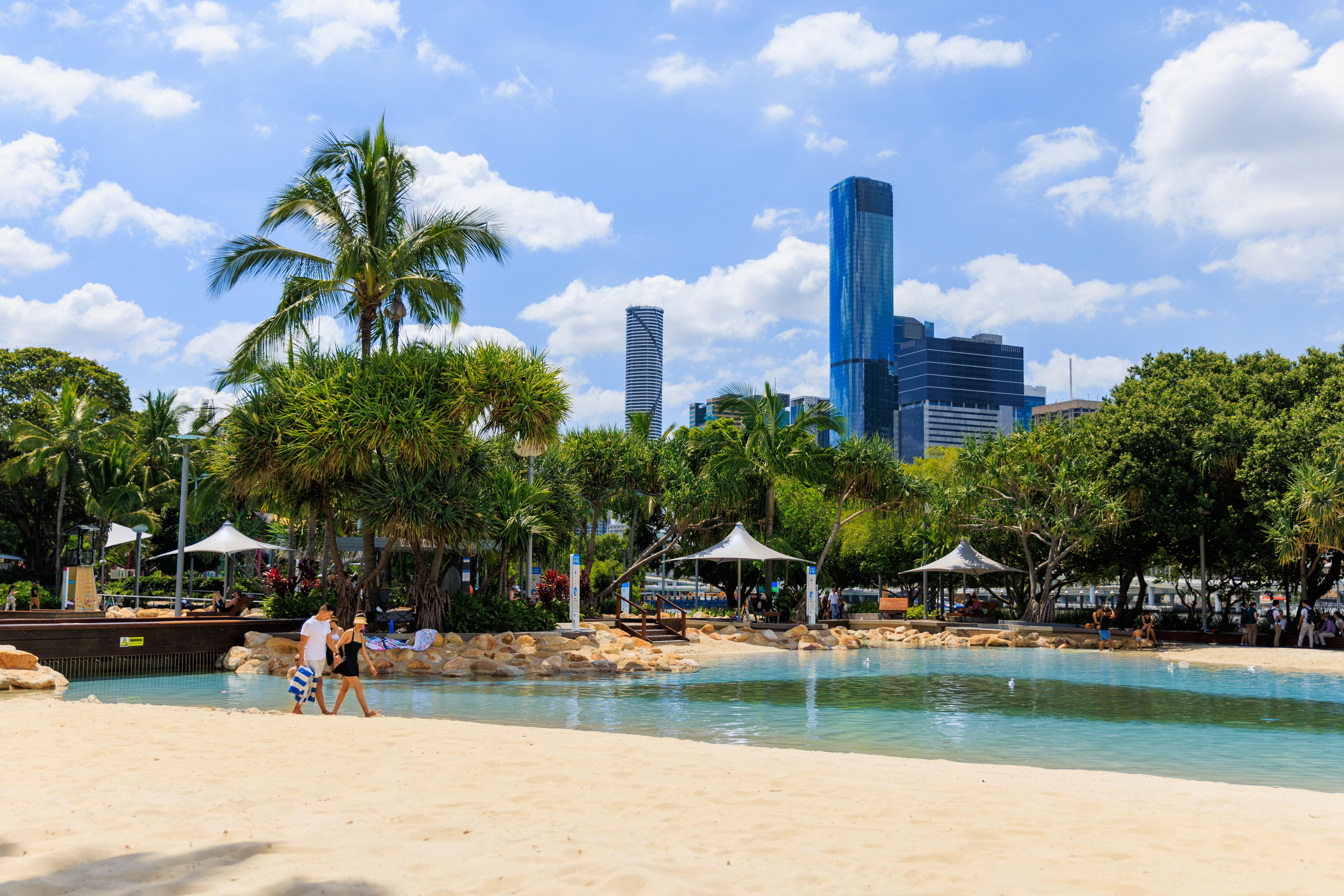 Swimming visitors at South Bank Parklands overlooking the Brisbane River
