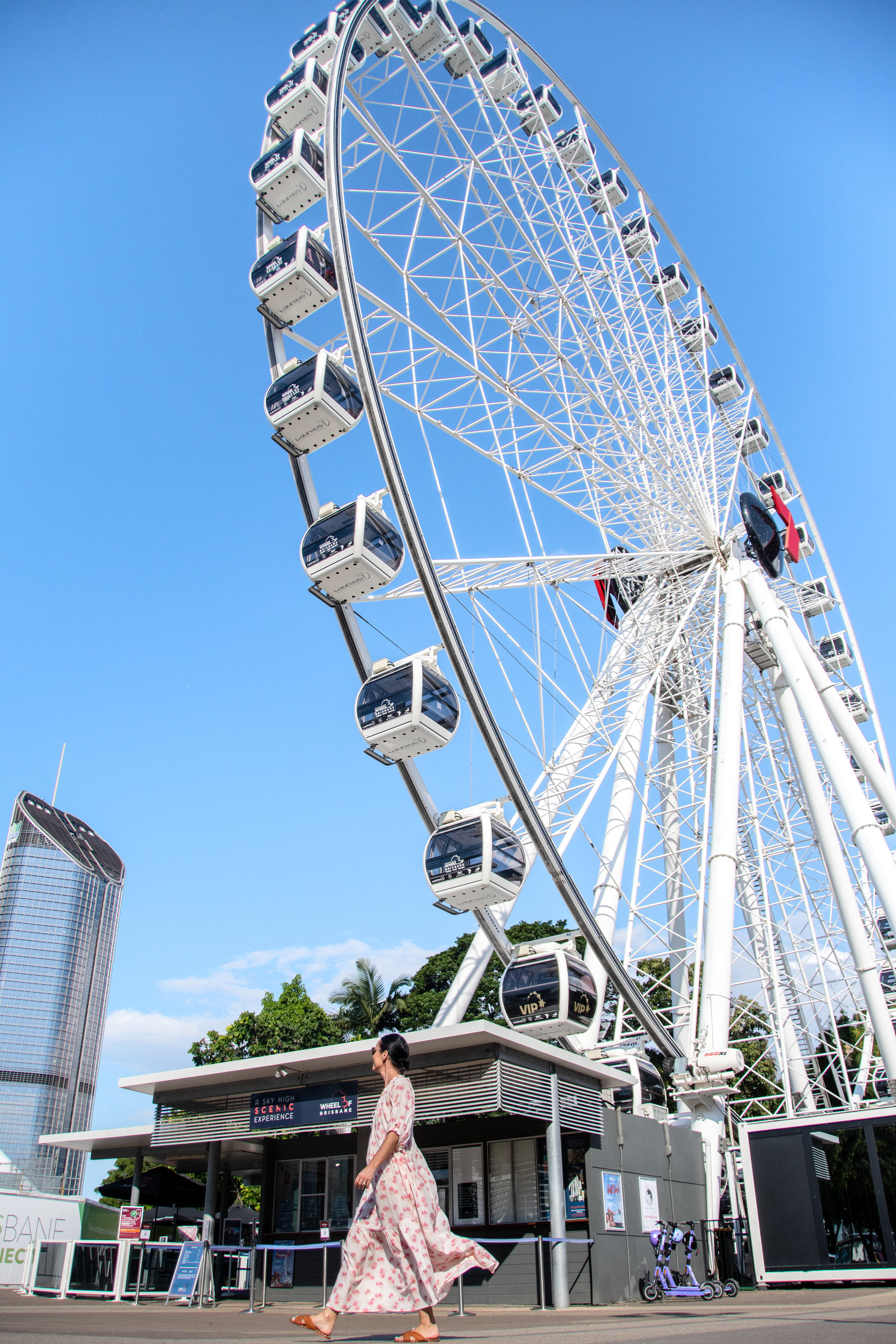 Lady walking past The Channel Seven Wheel of Brisbane South Bank Parklands