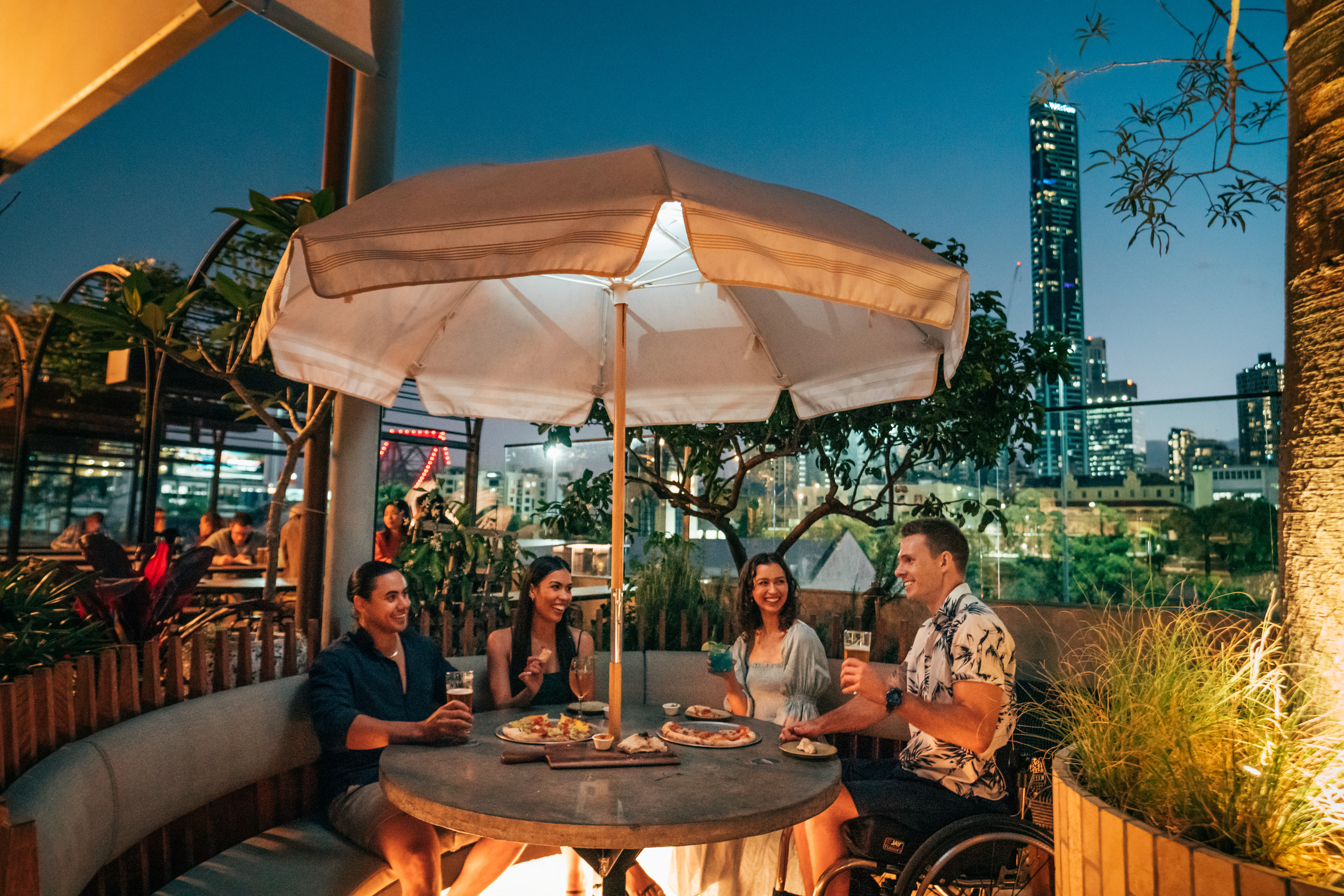 Group of friends enjoying food and drink outdoors at Valley Hops Brewing