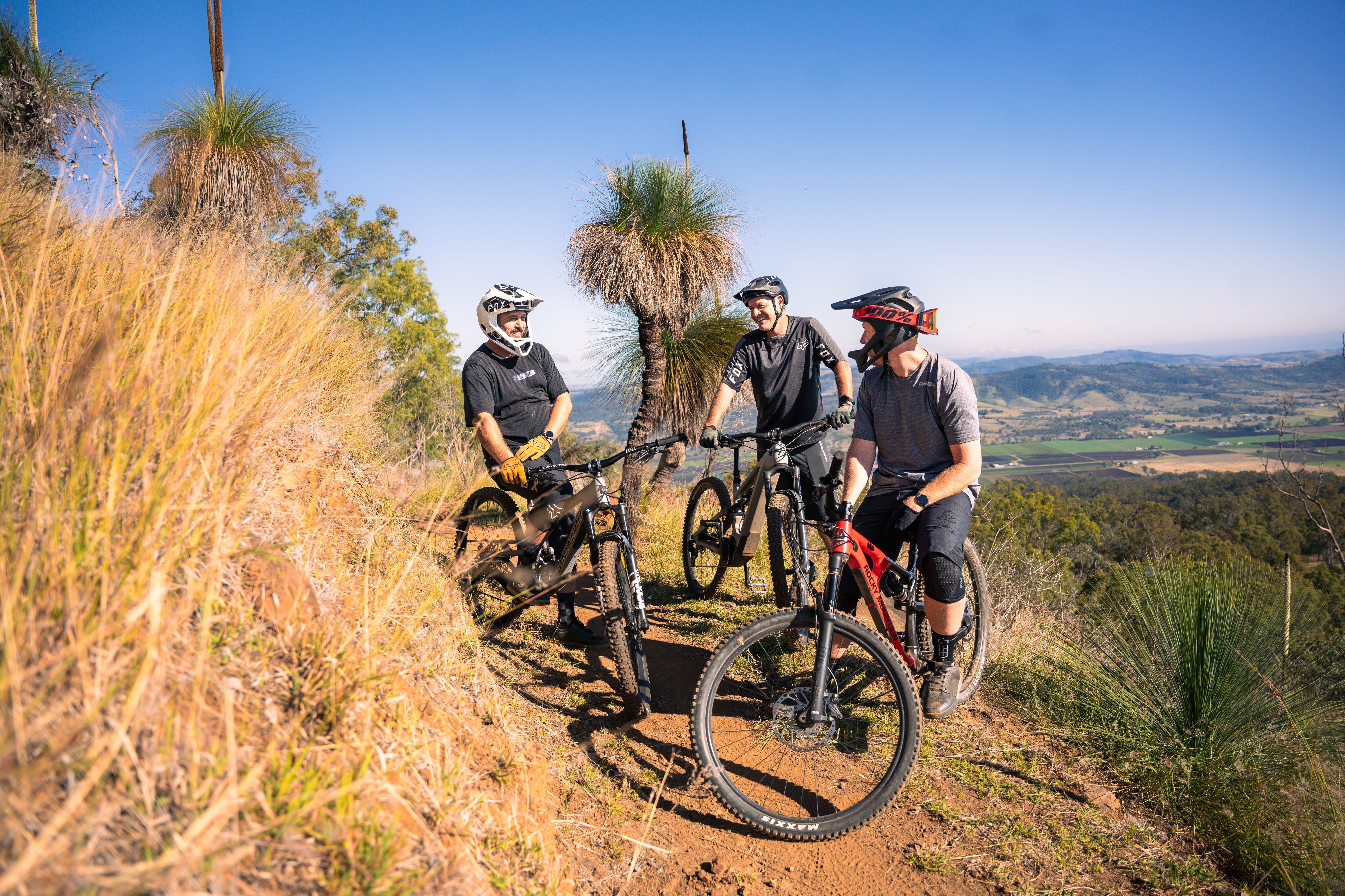 Three cyclists stop at the top of a hill at Hidden Vale Adventure Park