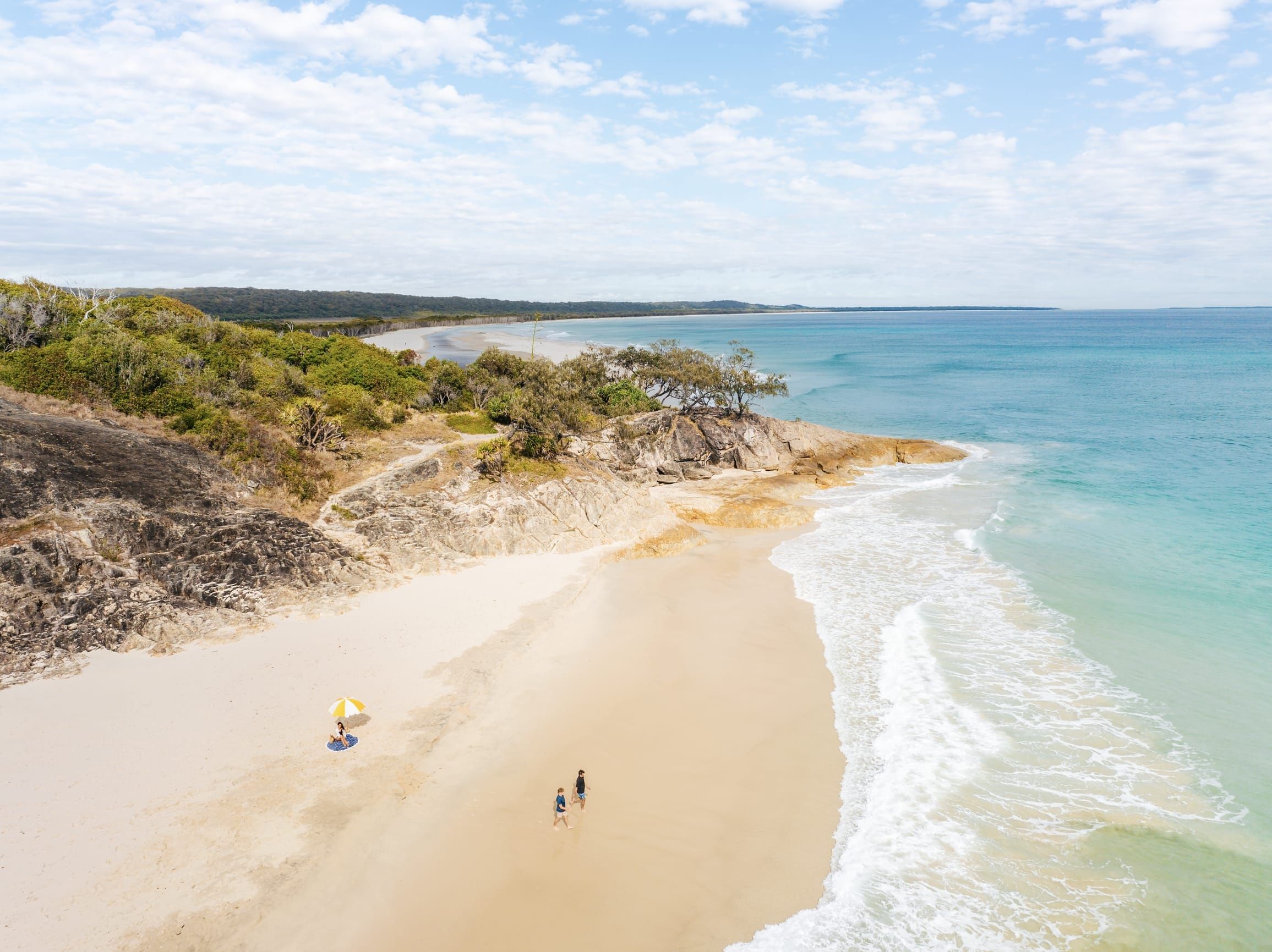 Friends relaxing at the iconic surf beach at the northern end of the island
