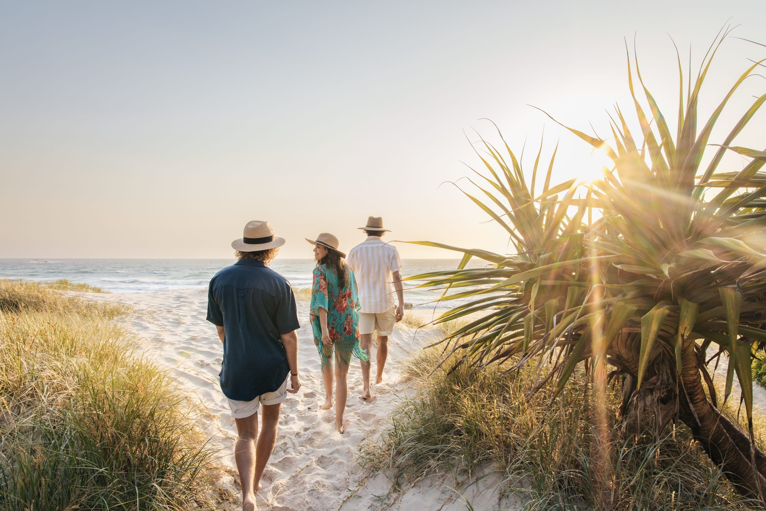 Friends enjoying sunrise at Frenchmans Beach, accessible by stairs at Point Lookout, Minjerribah