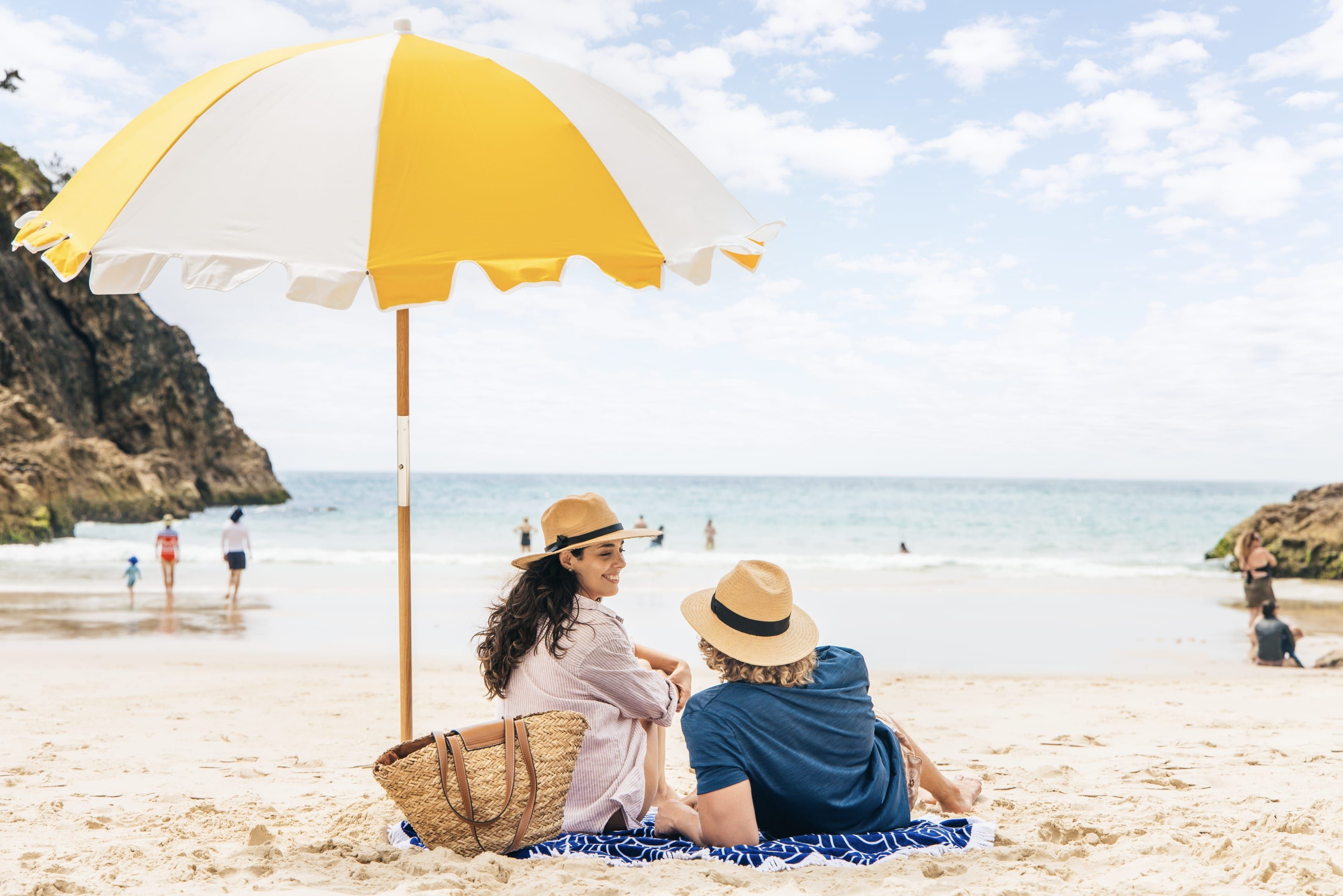 Couple relaxing on South Gorge Beach, the small secluded beach below the North Gorge Walk on Minjerribah (North Stradbroke Island)