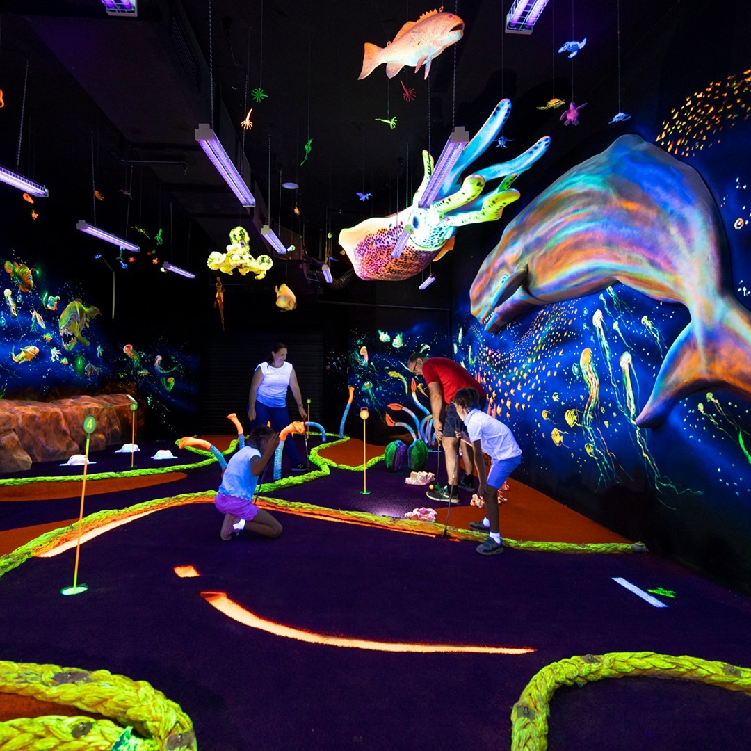 Family playing a round of mini golf at UnderSea Putt & Play, Redcliffe