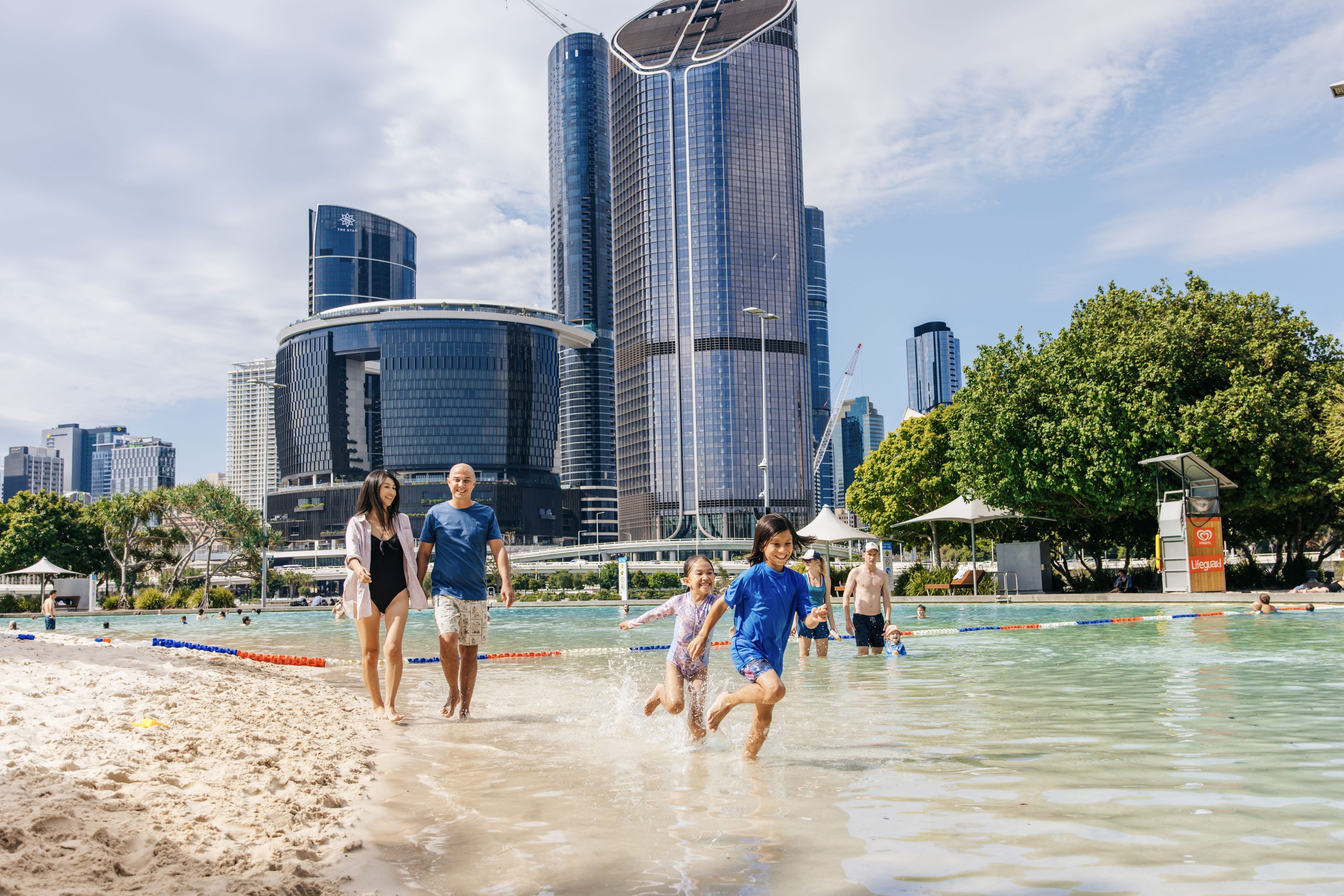 A family play in the water at Streets Beach in South Bank A family play in the water at Streets Beach in South Bank
