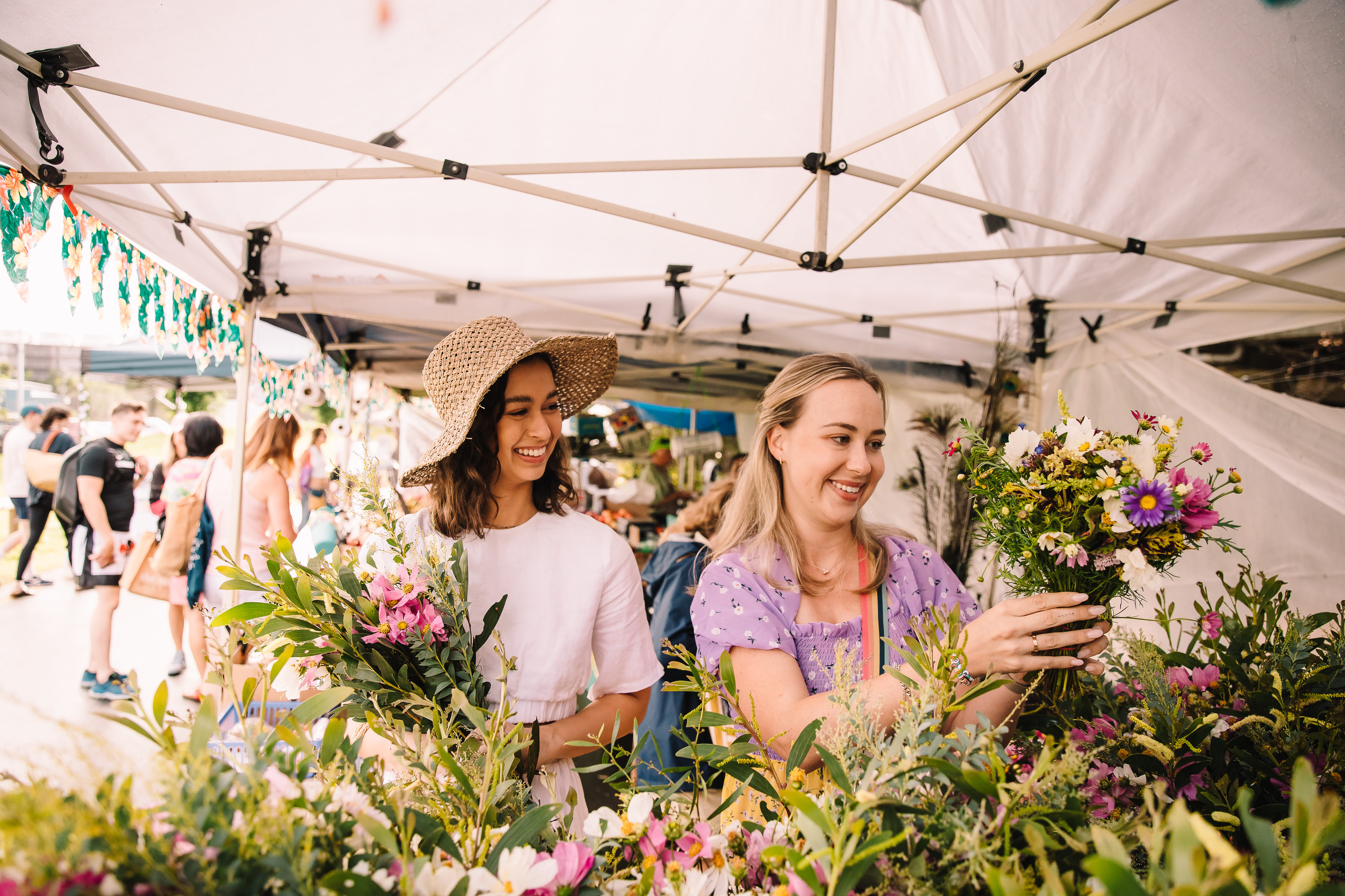 Ladies shopping for fresh flowers at the West End Markets
