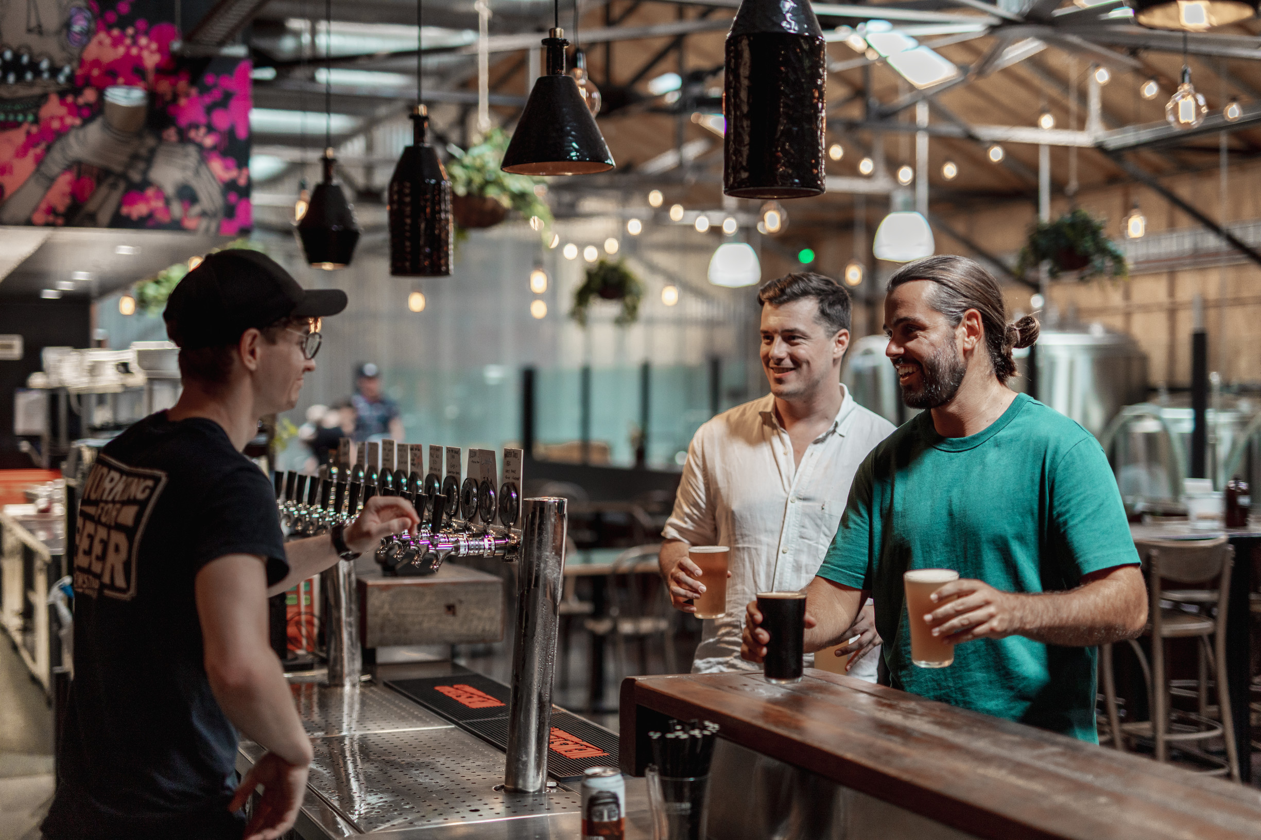 Friends grabbing beers at Newstead Brewery Brisbane | things to do when it rains Brisbane
