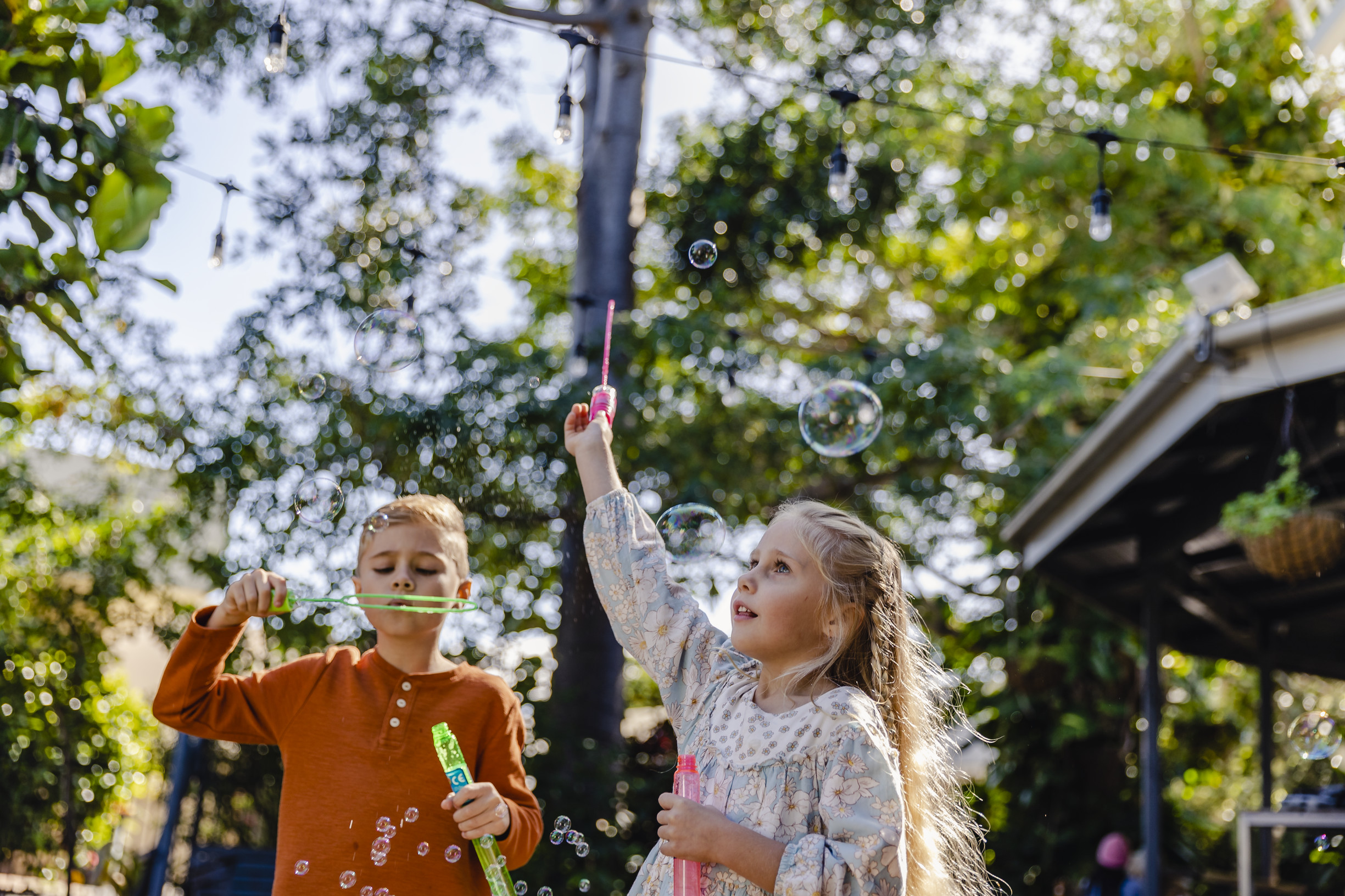 Two children making bubbles outside The Windmill Cafe, Bargara Two children making bubbles outside The Windmill Cafe, Bargara