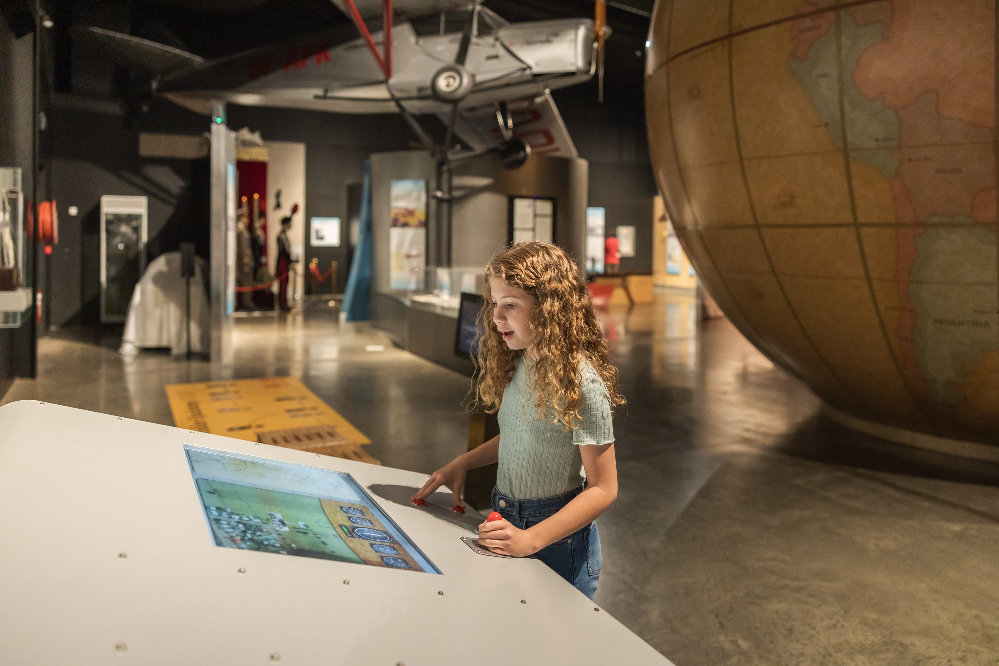 Young girl exploring Hinkler Hall of Aviation, a museum celebrating the life and achievements of Australia's aviation pioneer Bert Hinkler Young girl exploring Hinkler Hall of Aviation, a museum celebrating the life and achievements of Australia's aviation pioneer Bert Hinkler