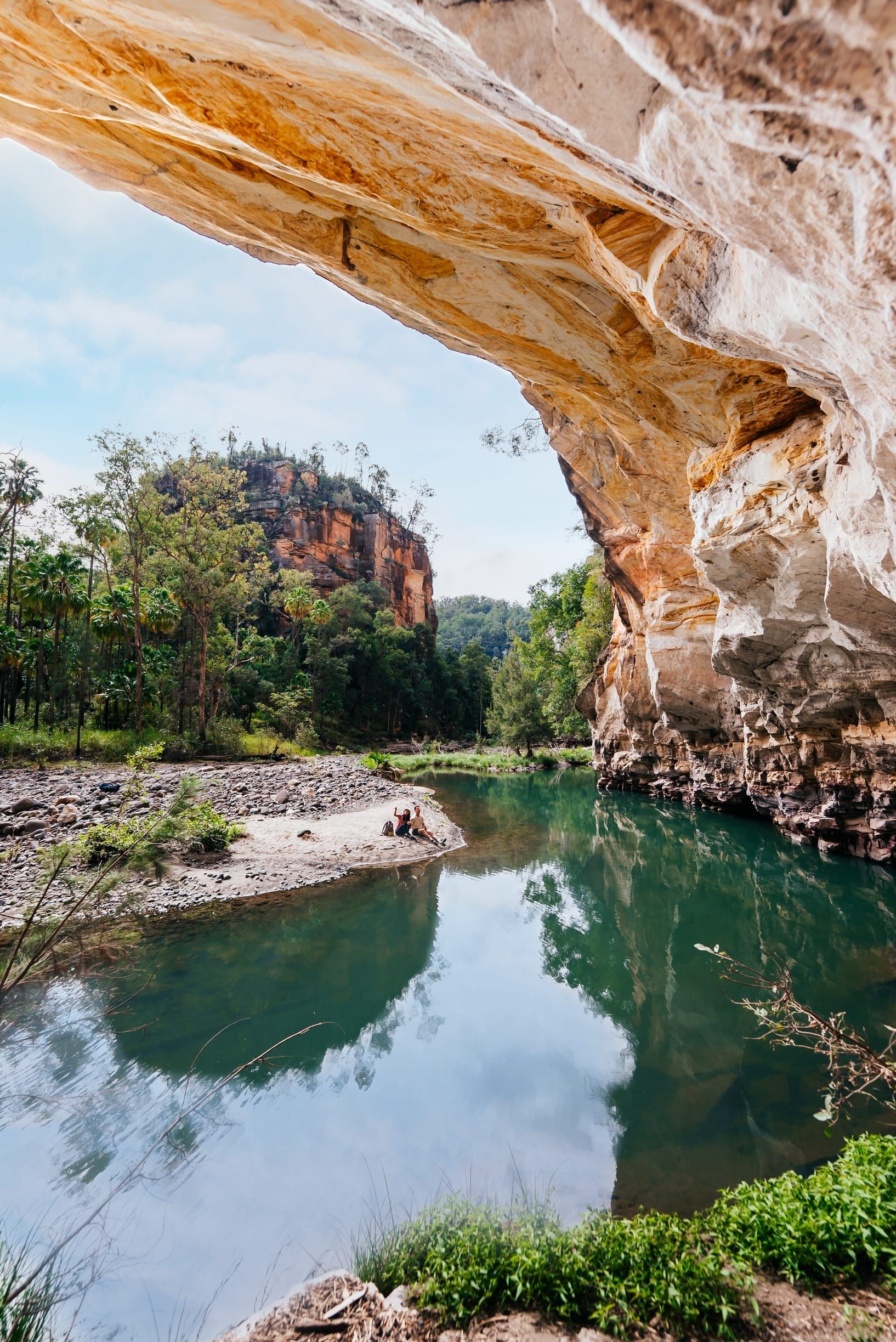Couple taking a self-guided walk through Carnarvon Gorge exploring the sandstone cliffs