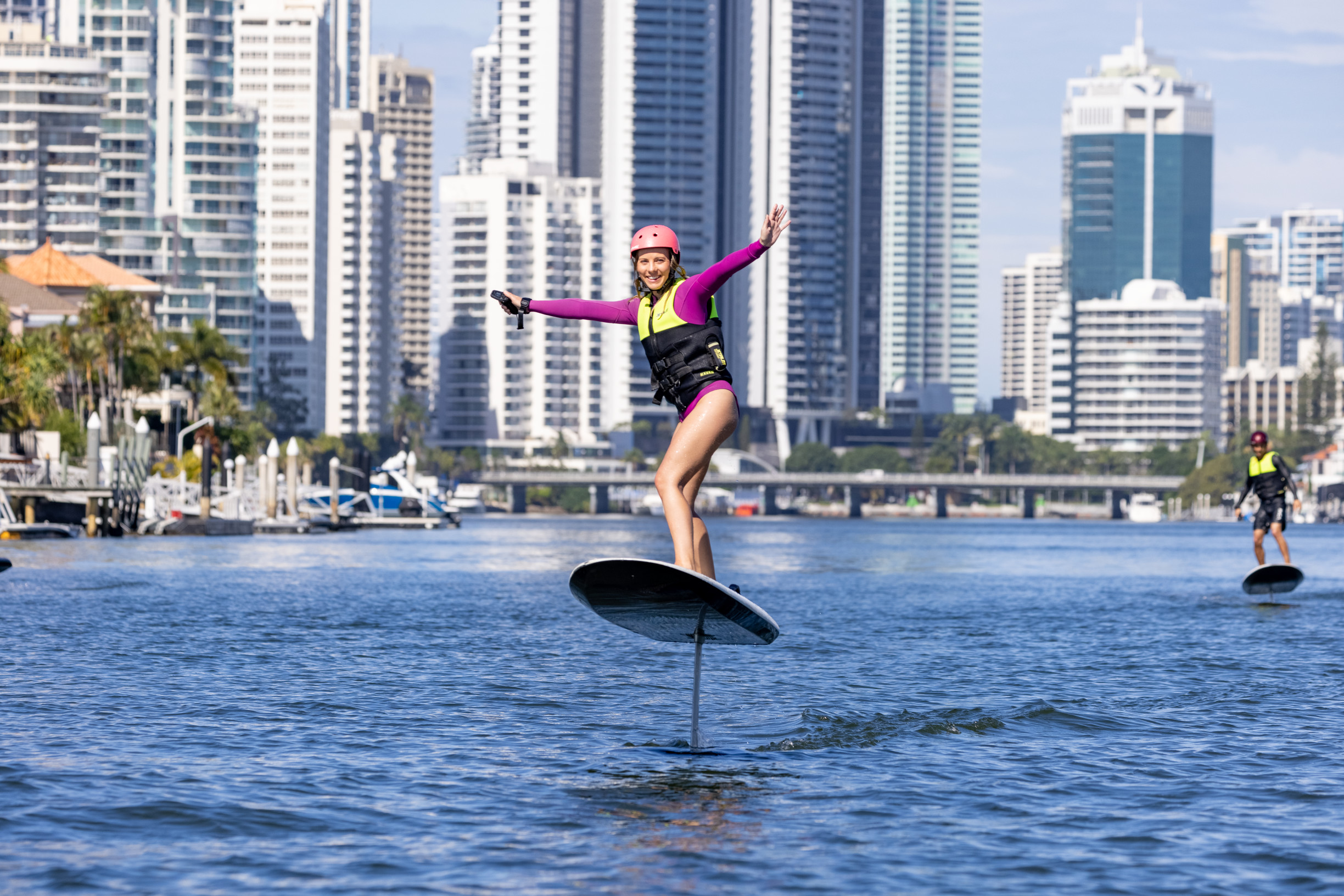 Woman rides a hydro foil through Gold Coast waterways
