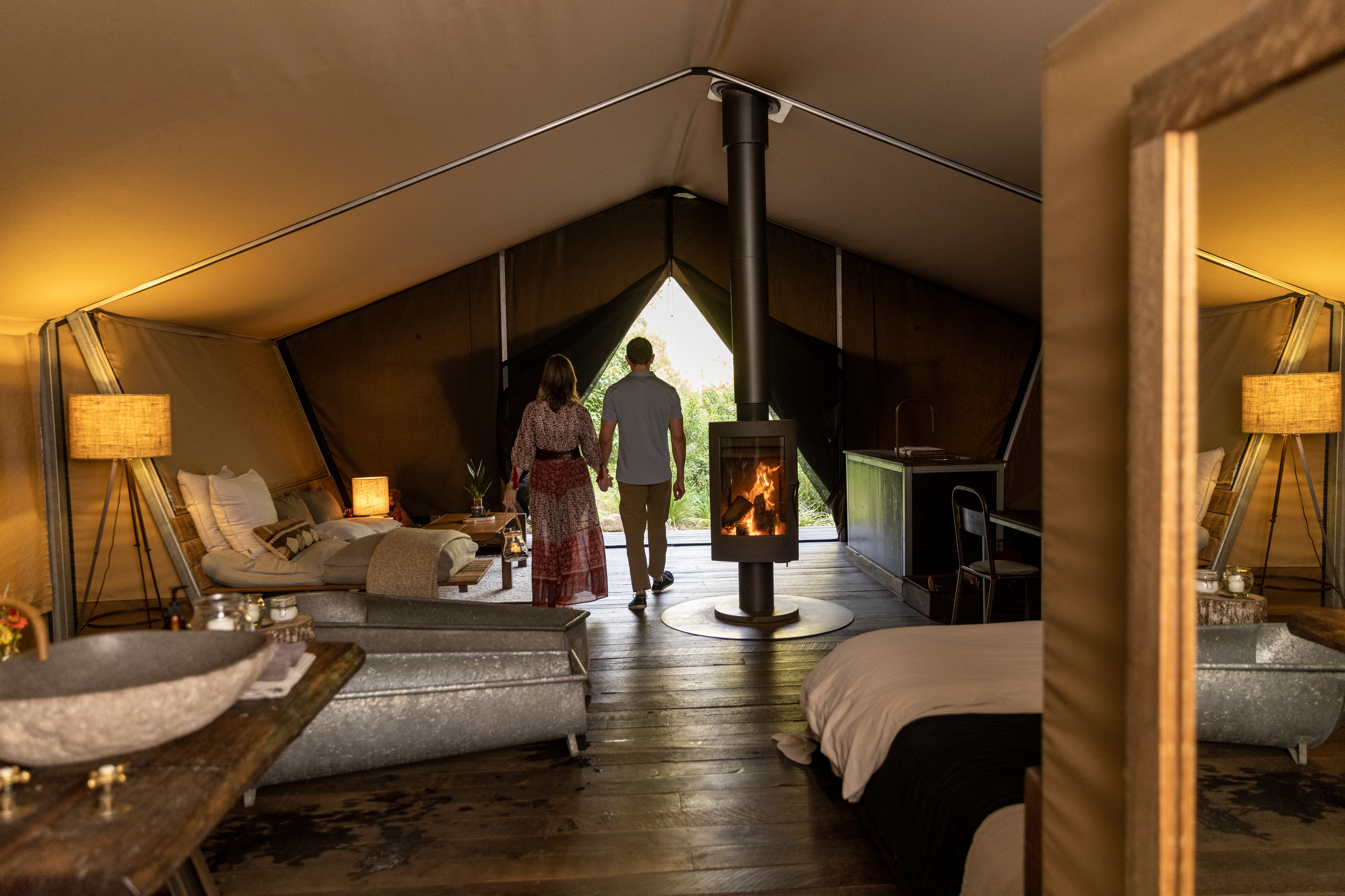 Couple in Nightfall's Safari Tent with fire burning | Brisbane luxury escapes with fireplaces Couple in Nightfall's Safari Tent with fire burning | Brisbane luxury escapes with fireplaces