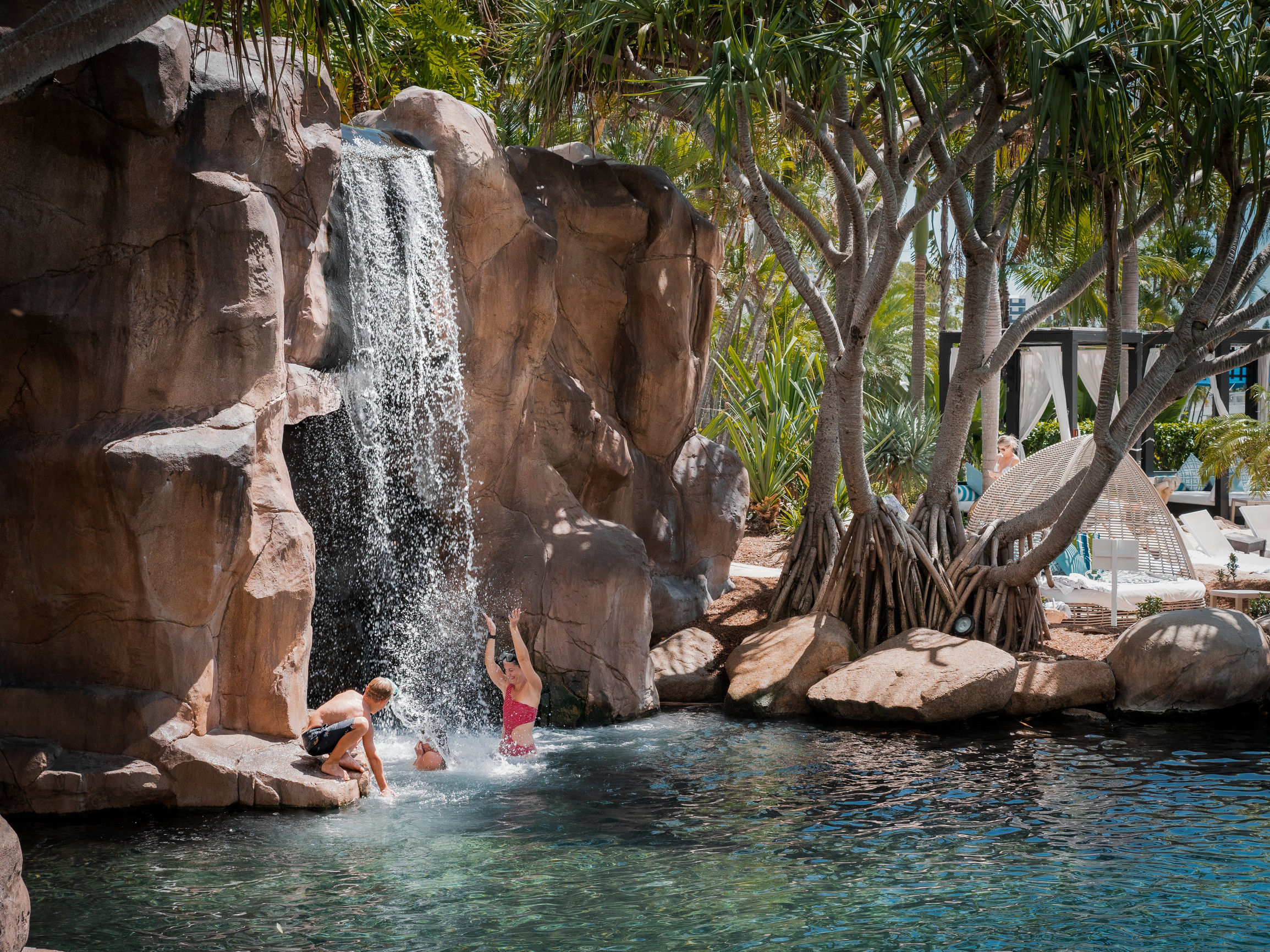 Family enjoying the waterfall in the resort's outdoor pool JW Marriott Gold Coast Resort & Spa
