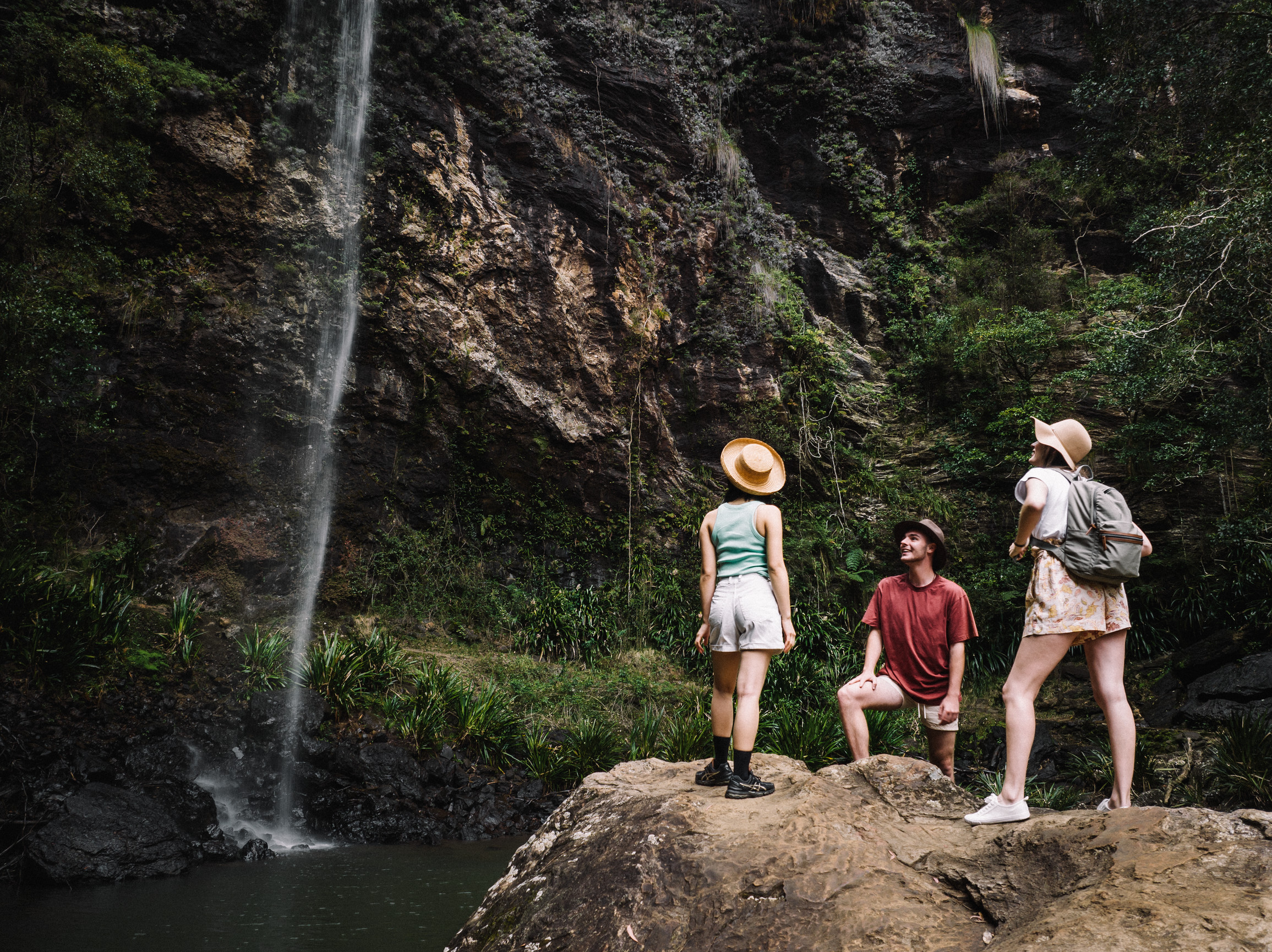 Group hiking at the base of Twin Falls, Springbrook National Park