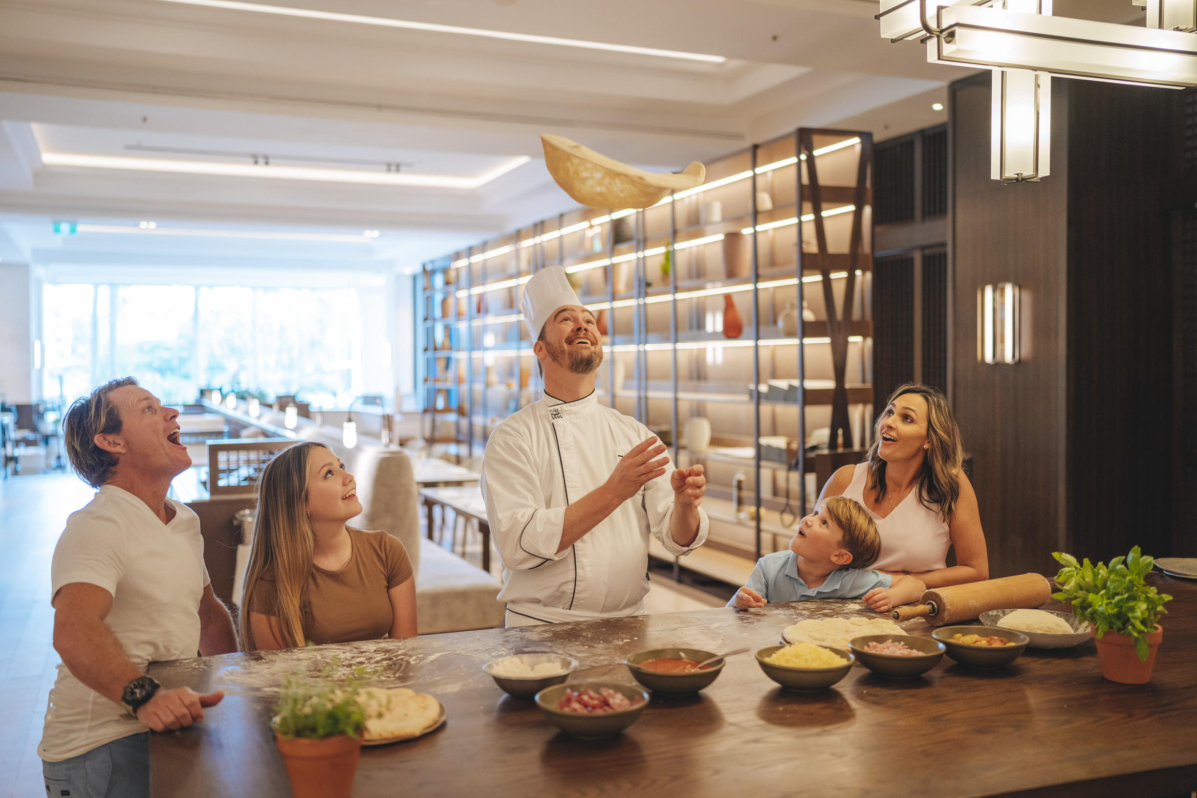 Family enjoying a pizza making class, as part of Family by JW, JW Marriott Gold Coast Resort & Spa