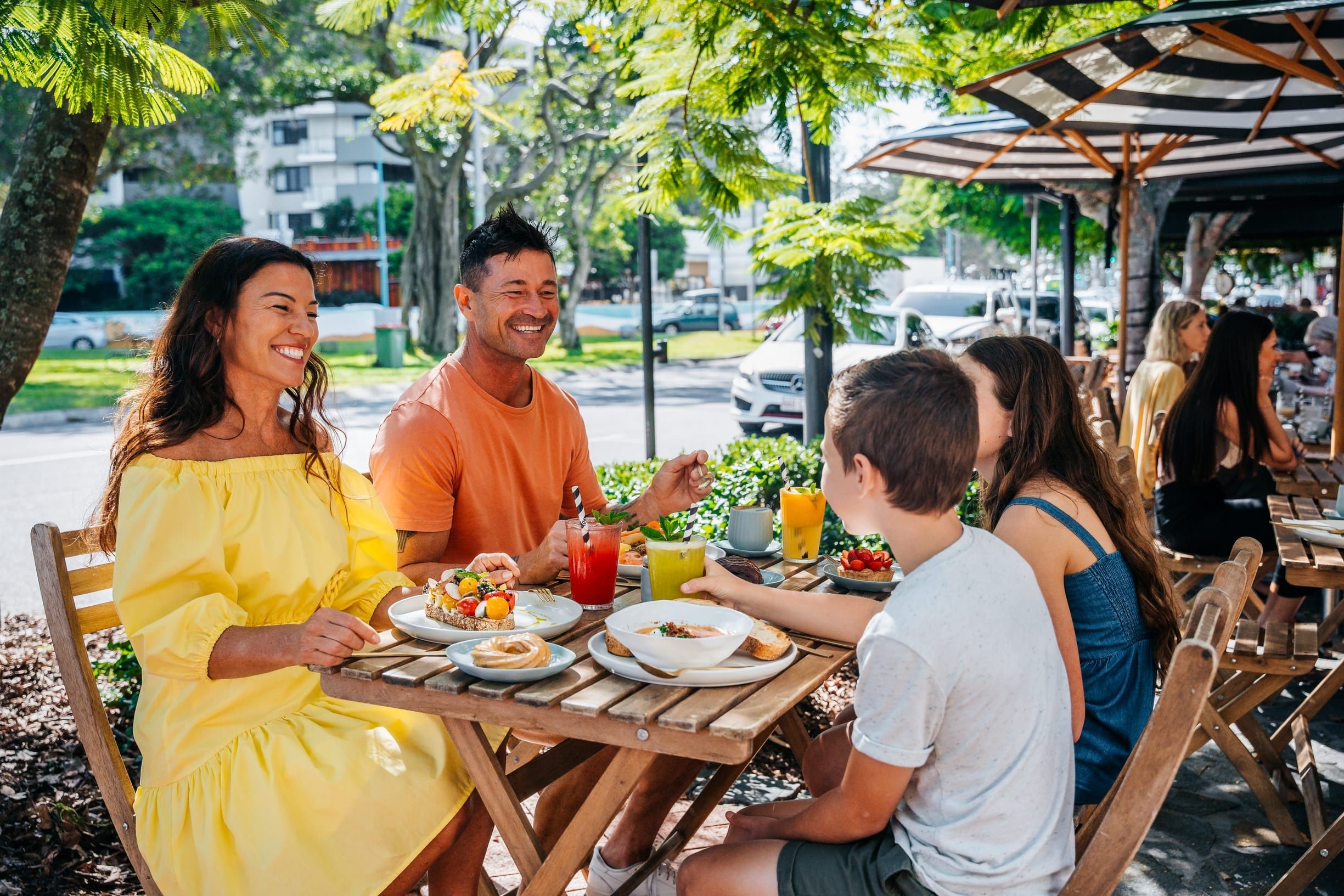 Family of four dine alfresco by the street at Tarte Bakery & Cafe, Burleigh Heads Family of four dine alfresco by the street at Tarte Bakery & Cafe, Burleigh Heads