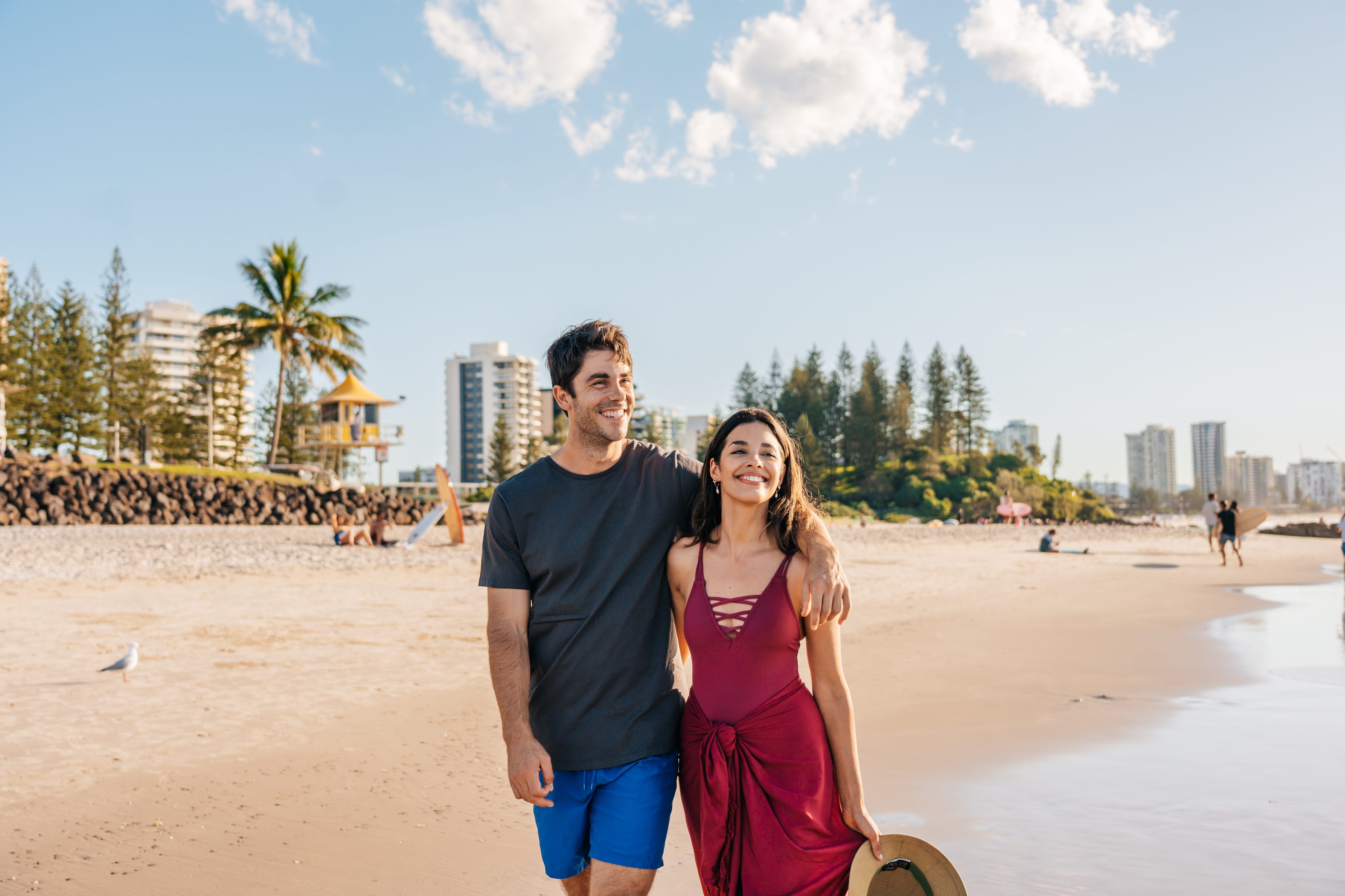 Couple walking along Rainbow Bay Beach on the Gold Coast Couple walking along Rainbow Bay Beach on the Gold Coast