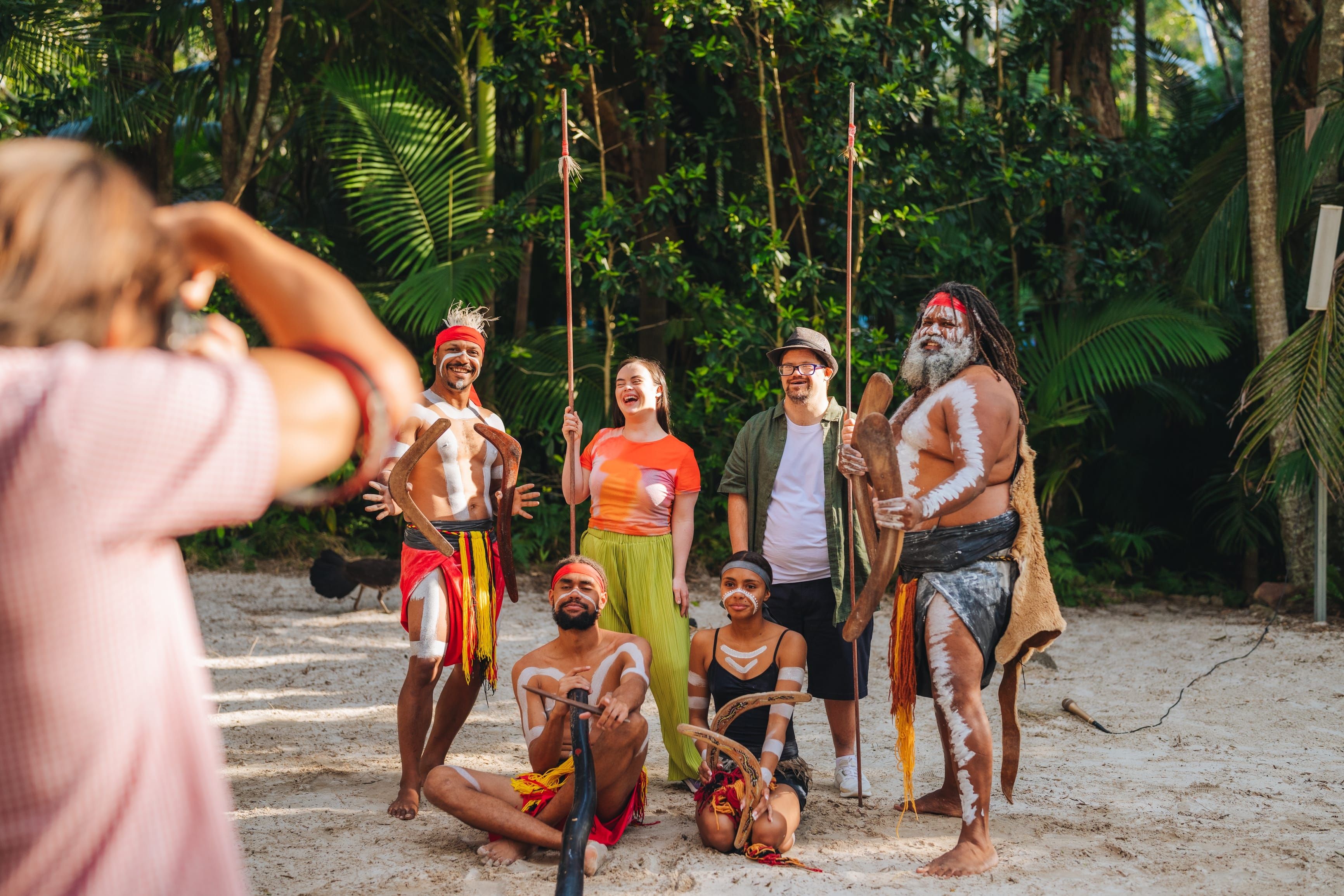 Guest posing for a photo with the  Aboriginal & Dance Show at Currumbin Wildlife Sanctuary