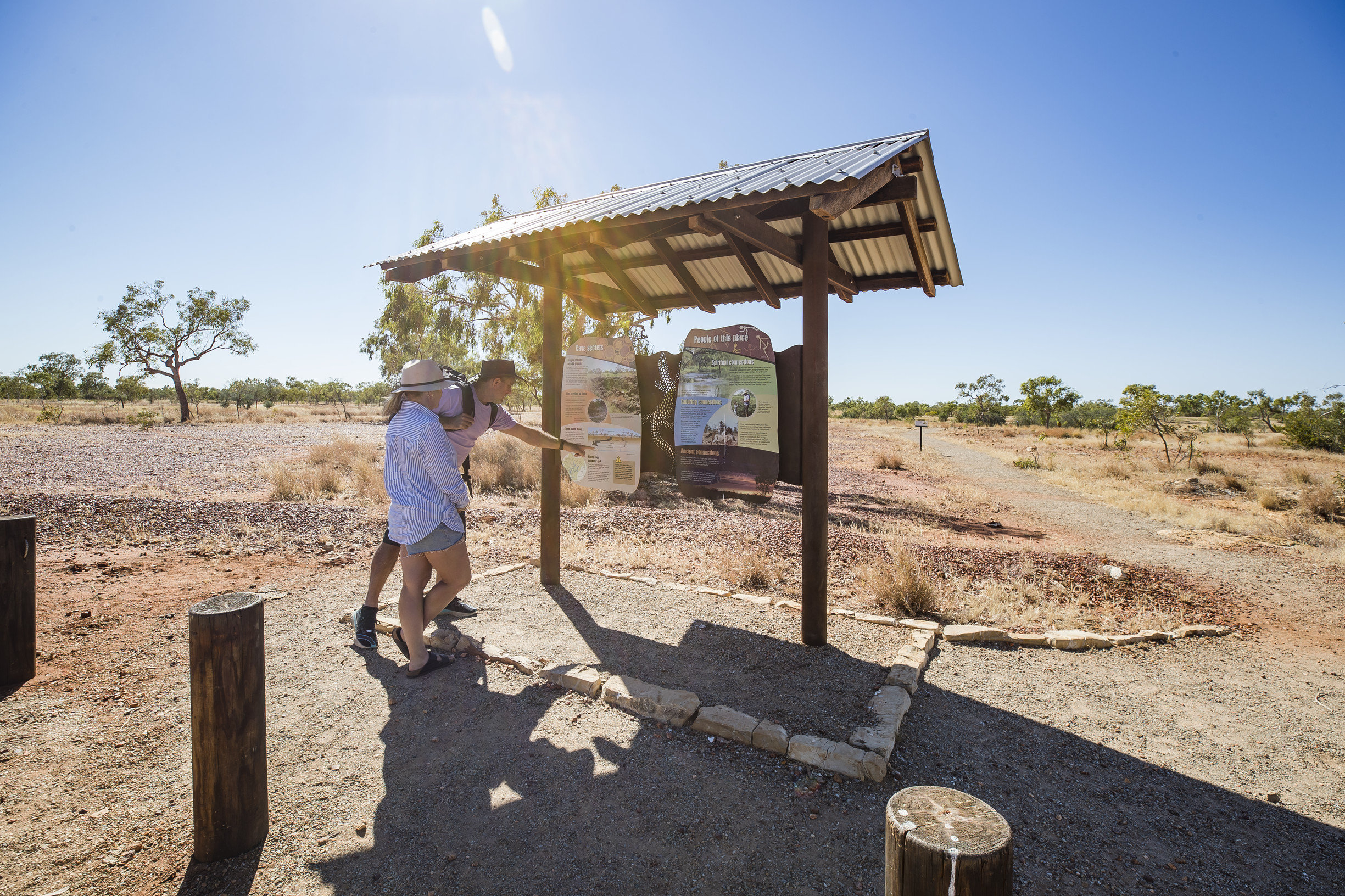 A couple looking at a map at Wiliyan-ngurru National Park (Camooweal Caves National Park) A couple looking at a map at Wiliyan-ngurru National Park (Camooweal Caves National Park)