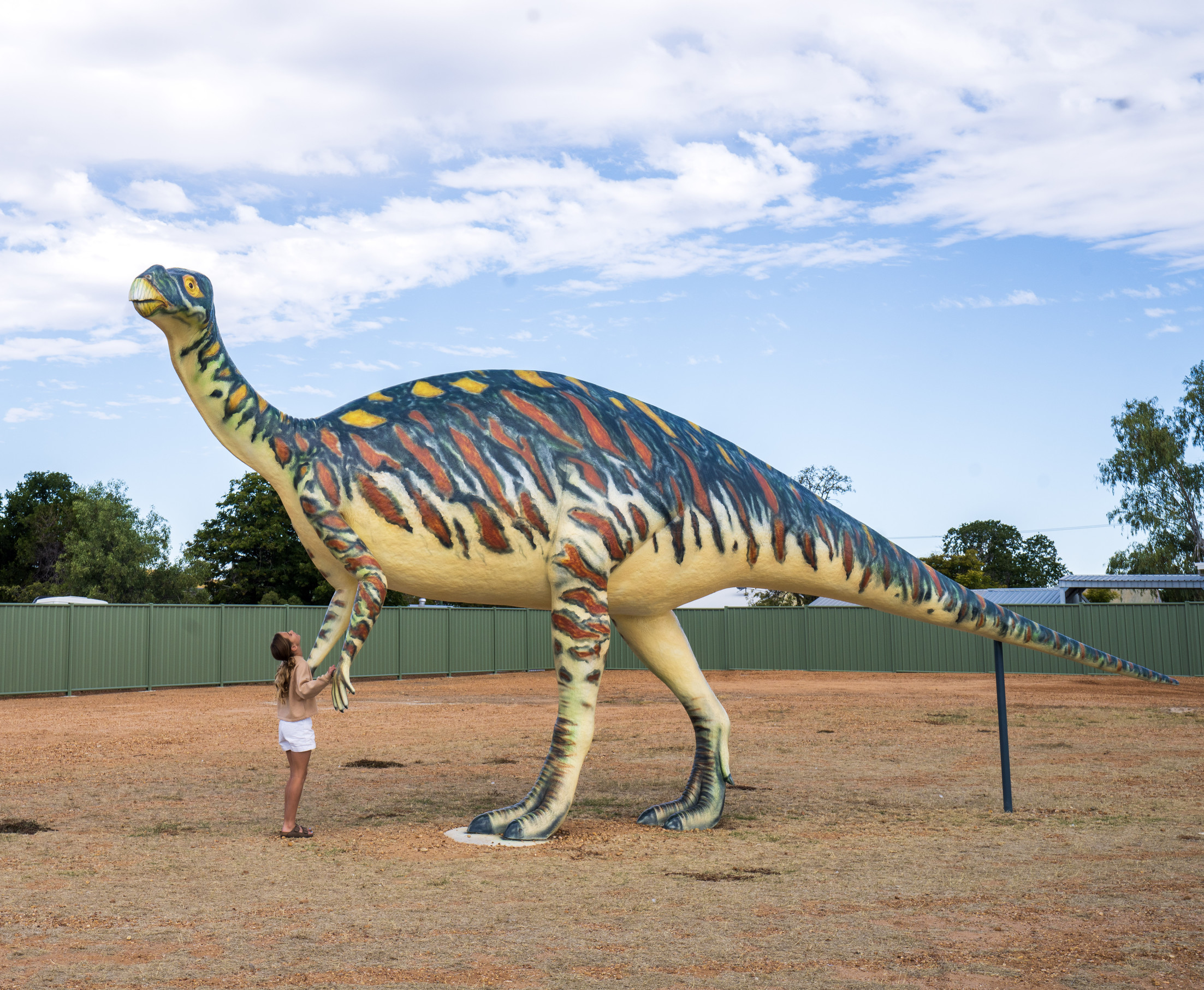 Girl looking at "Hughie" the dinosaur Flinders Discovery Centre | Best things to do for teenagers Queensland