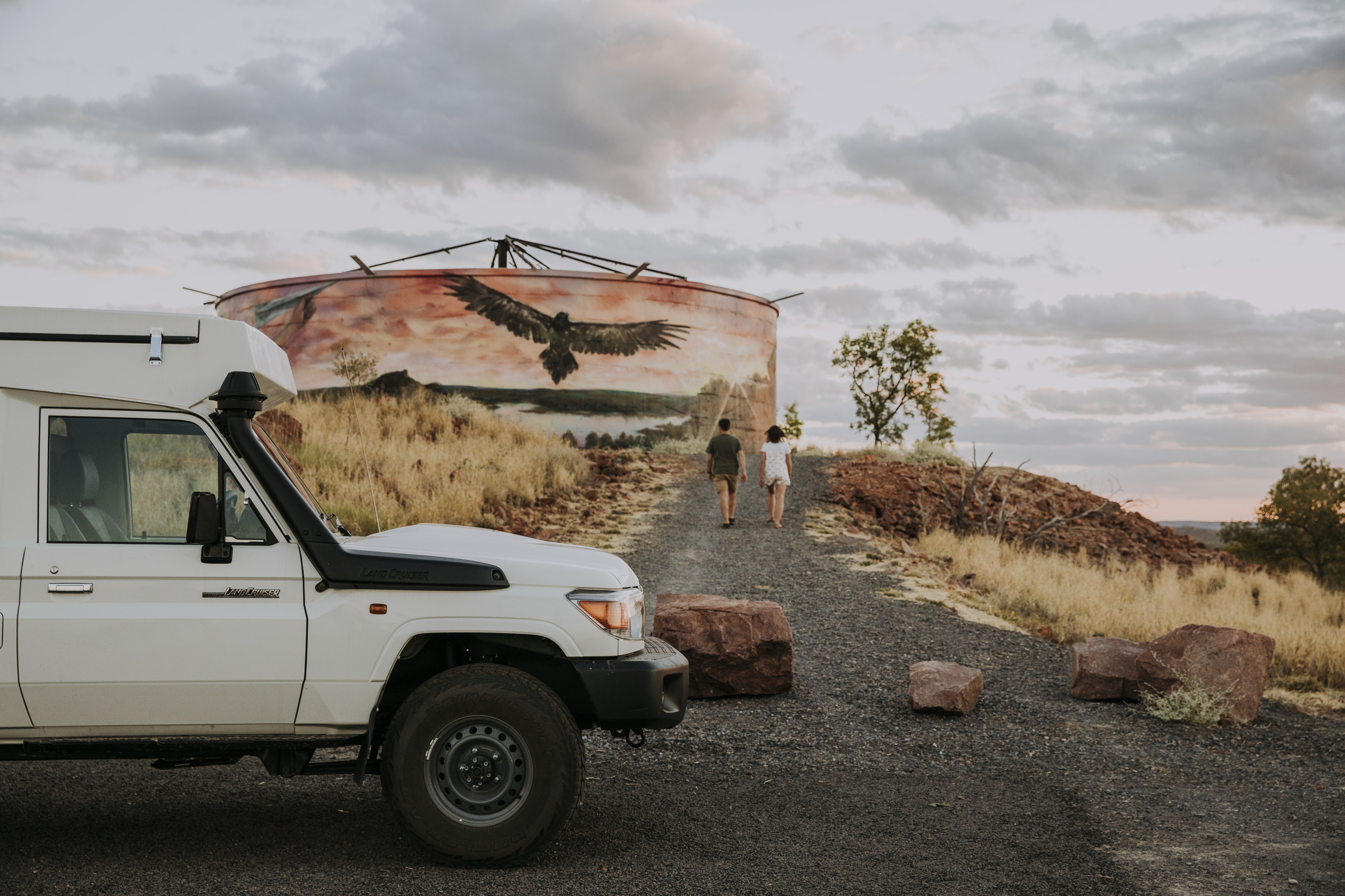 couple walking towards Cloncurry Water tank mural 