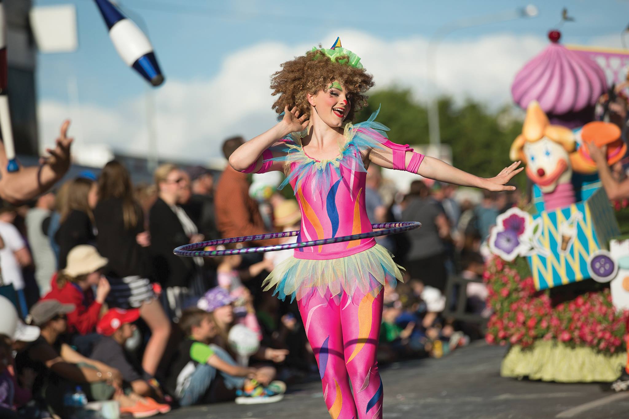 Colourful performers march down street during Grand Central Floral Parade, Toowoomba Carnival of Flowers