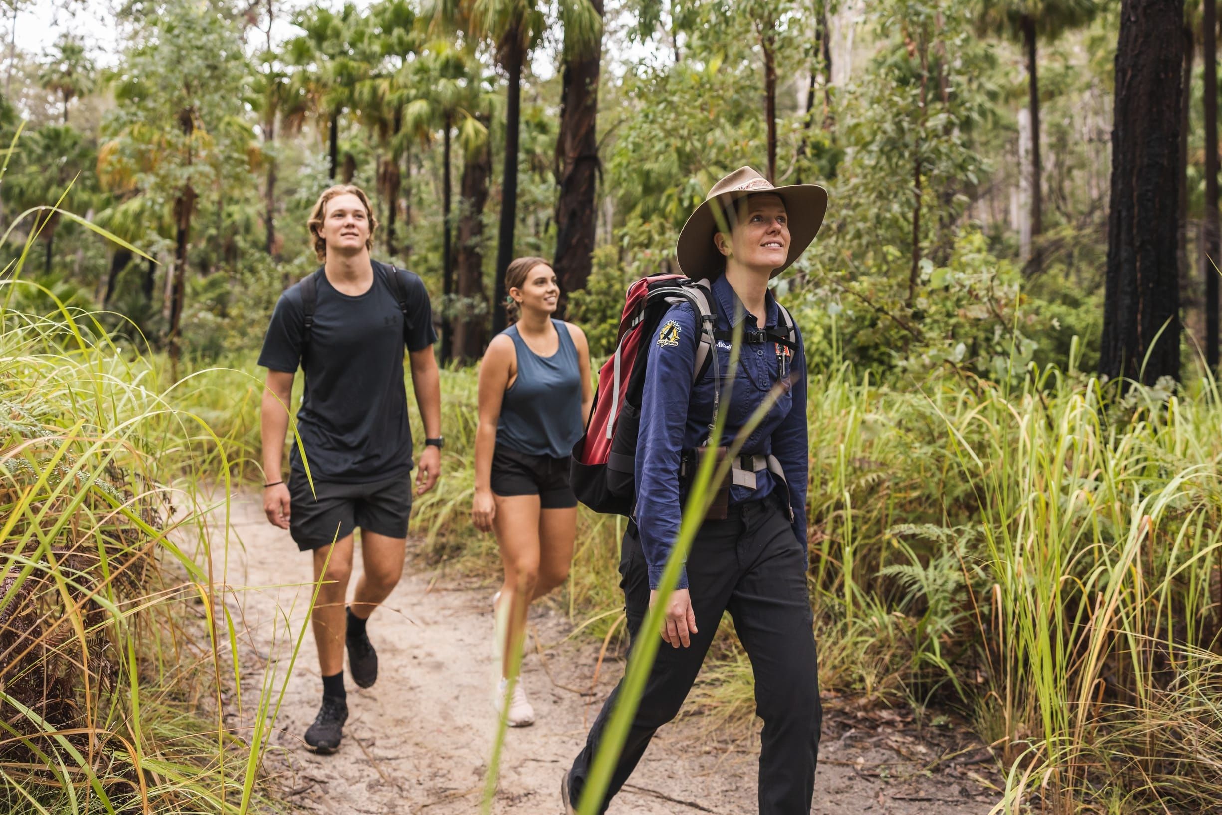 Two hikers on a hike with a tour guide