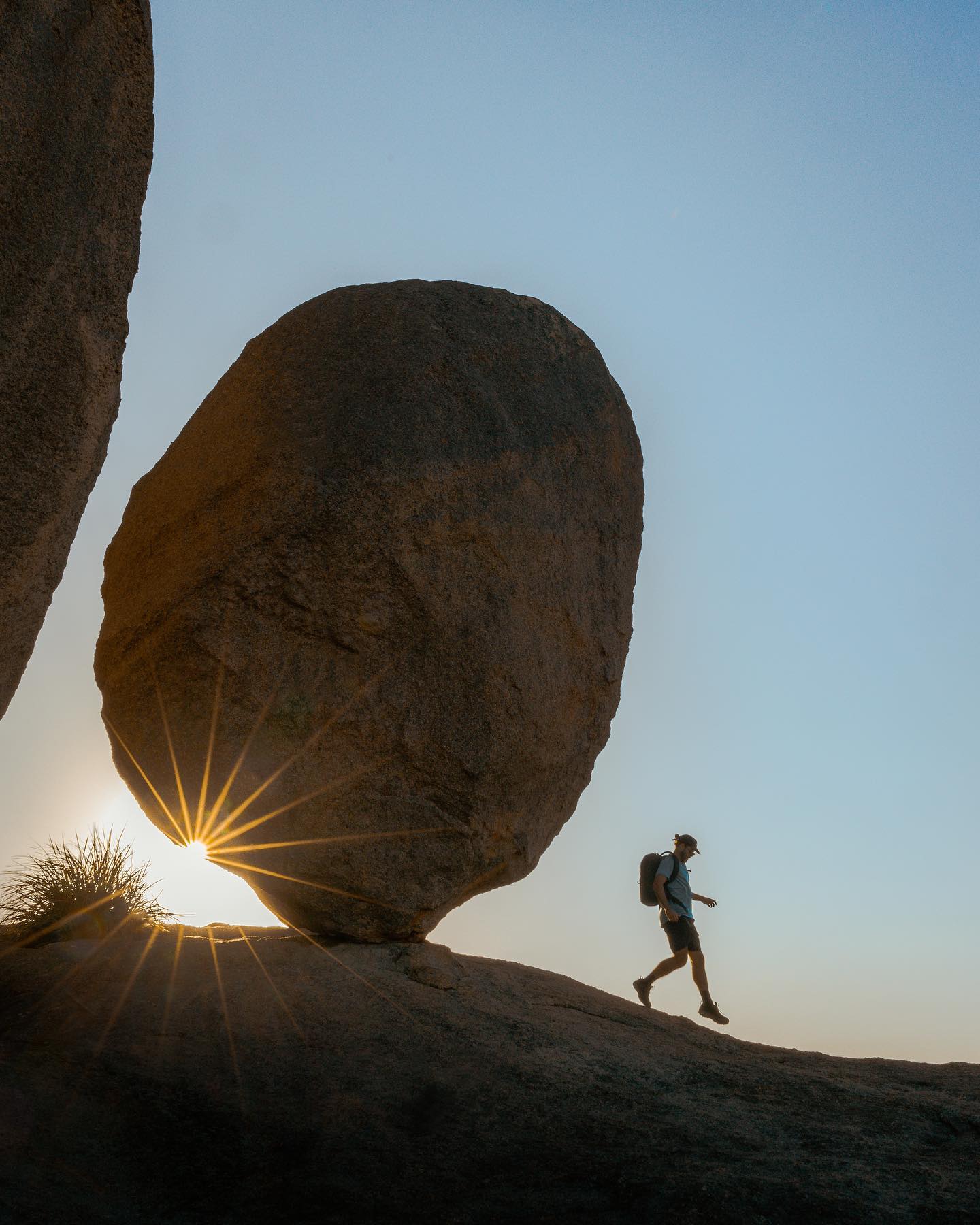 Hiker walking past Balancing Rock at Girraween National Park 