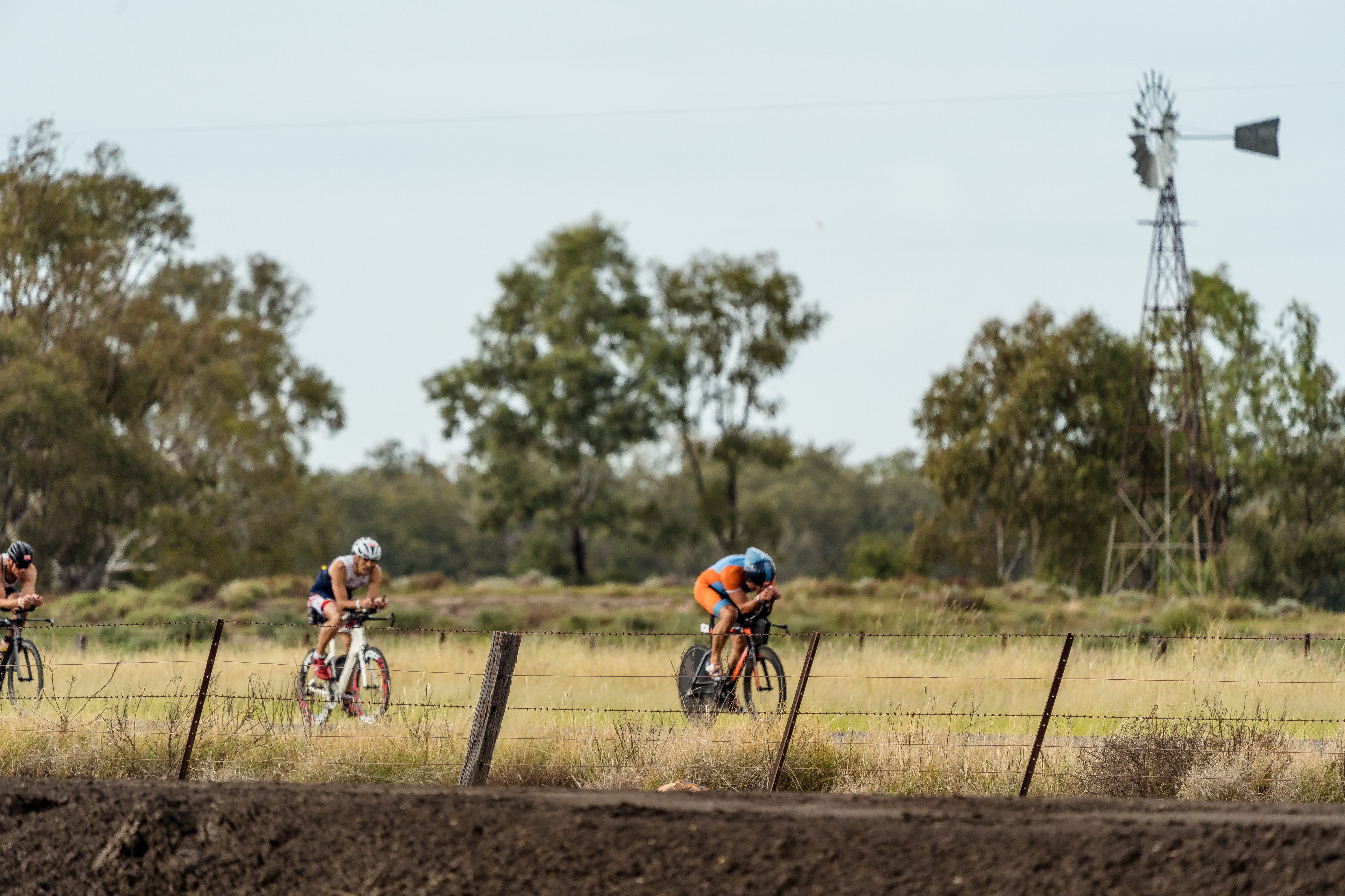 Cyclists competing on a country road at Hell of the West