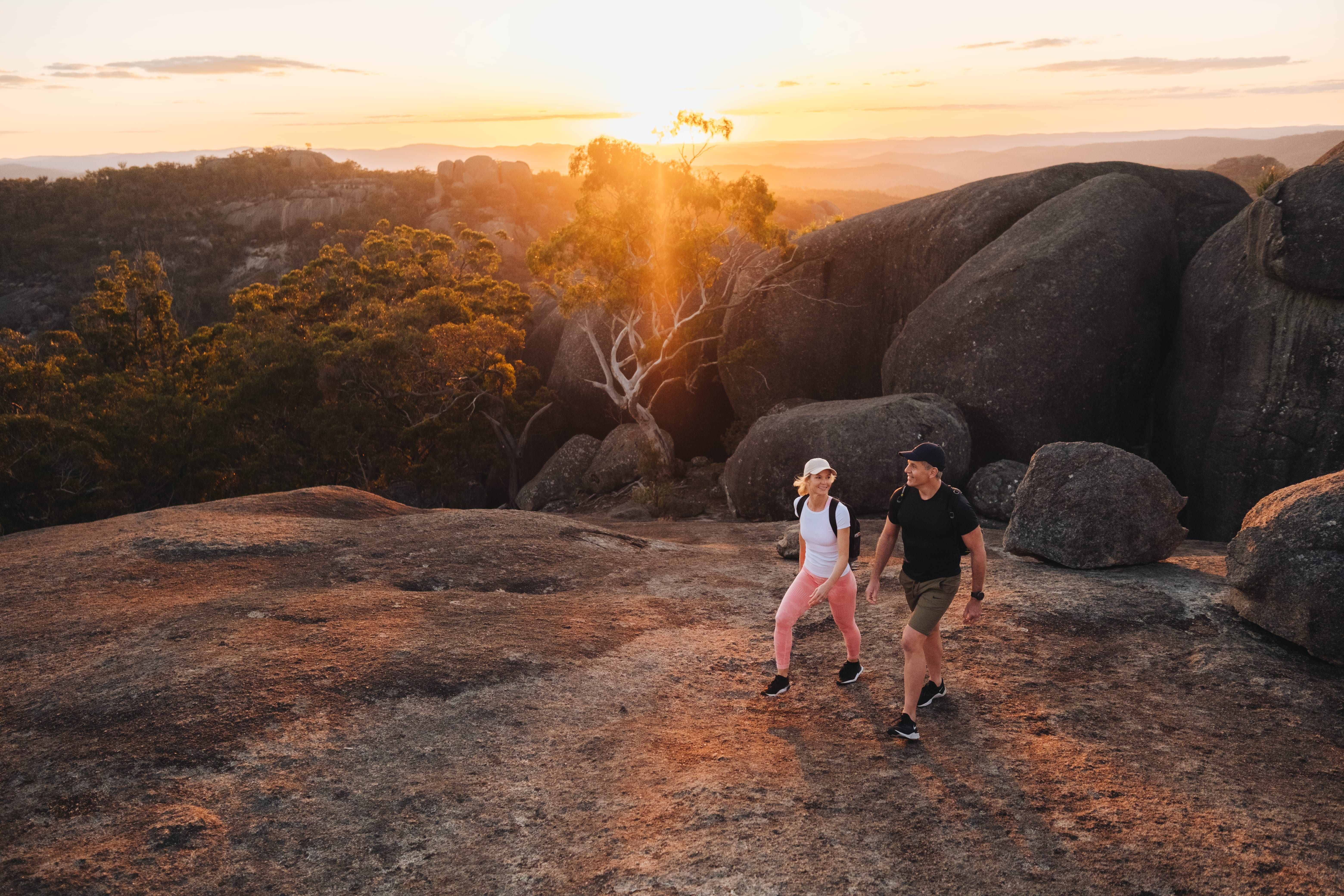 Couple exploring the granite formations along Mount Norman Trail, Girraween National Park