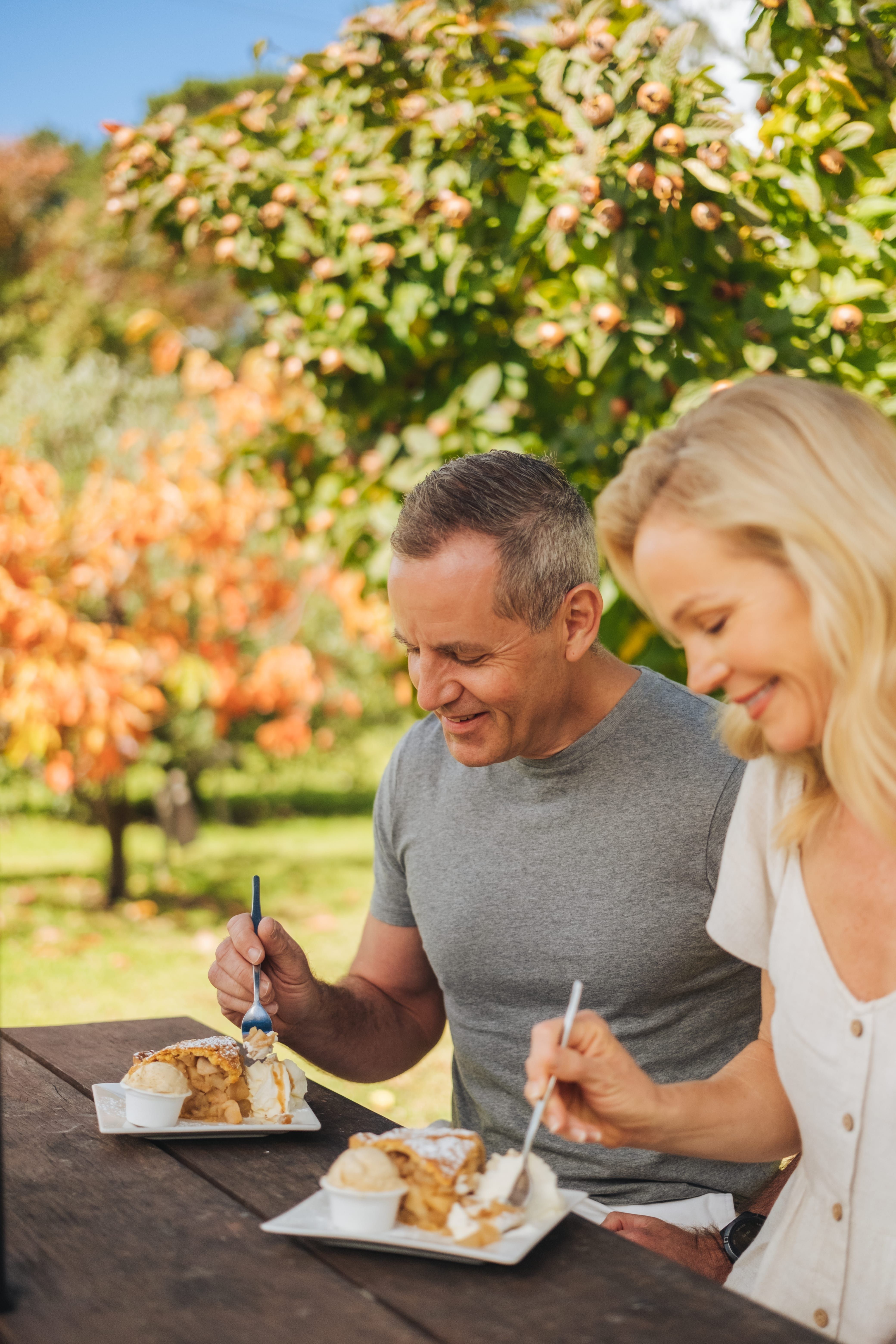 Couple eating apple pie at Suttons Juice Factory, Stanthorpe