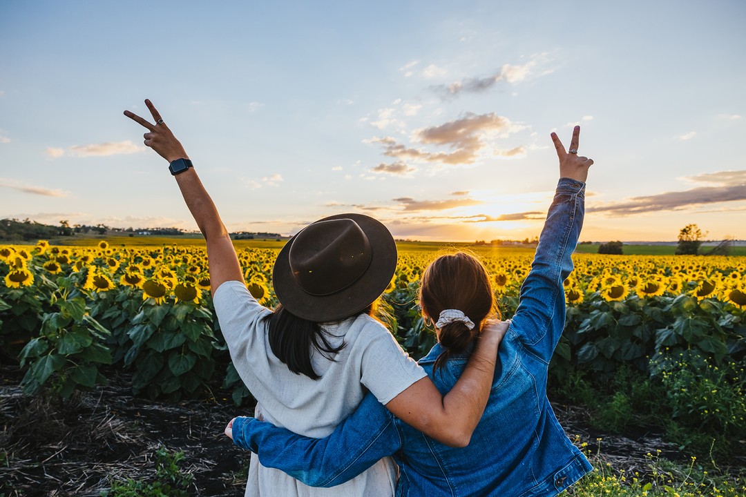 Mother and daughter watching the sunset in the sunflower fields Scenic Rim Mother and daughter watching the sunset in the sunflower fields Scenic Rim