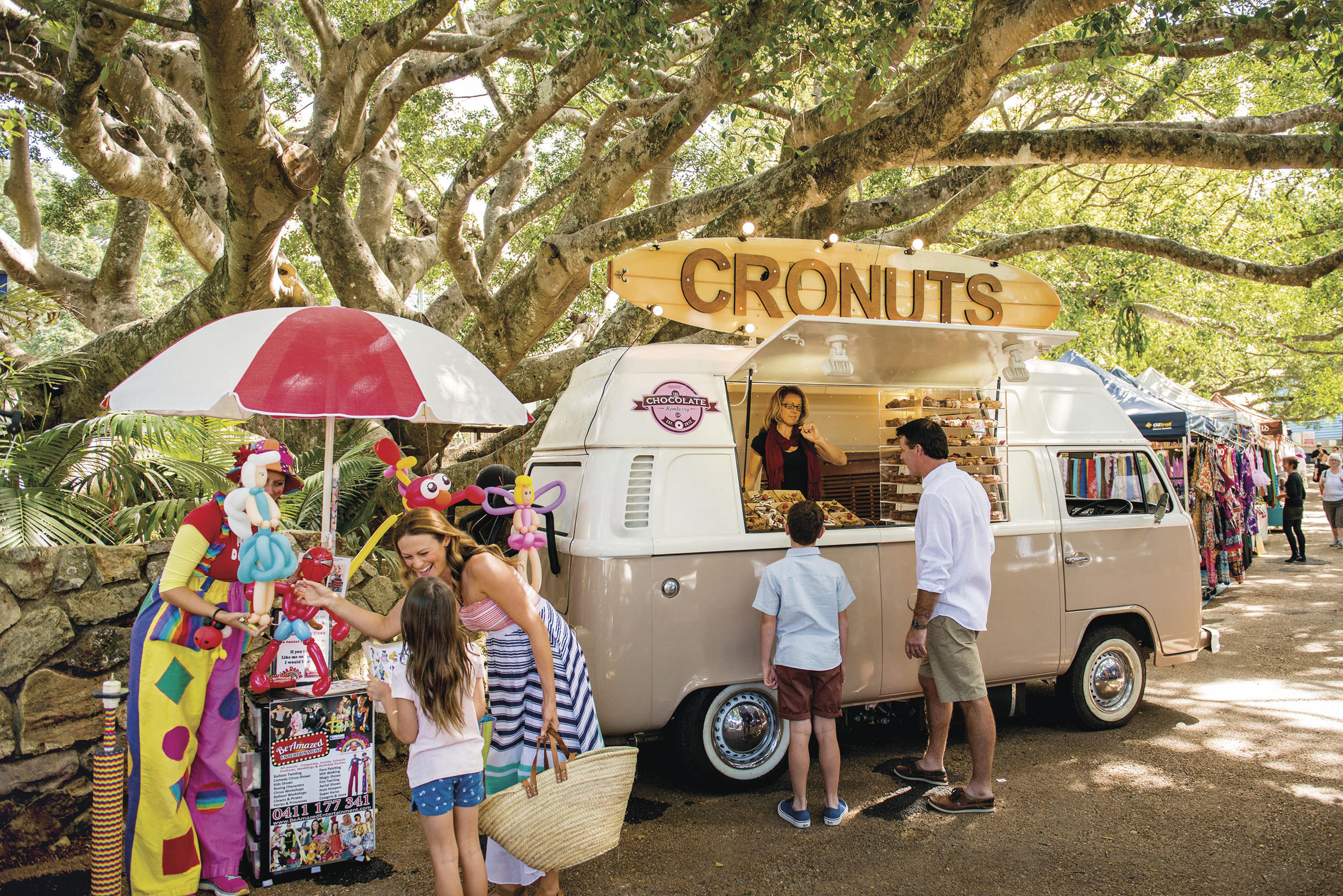 A group purchasing pastries from a stallholder at Eumundi Markets | Budget Sunshine Coast holiday A group purchasing pastries from a stallholder at Eumundi Markets | Budget Sunshine Coast holiday