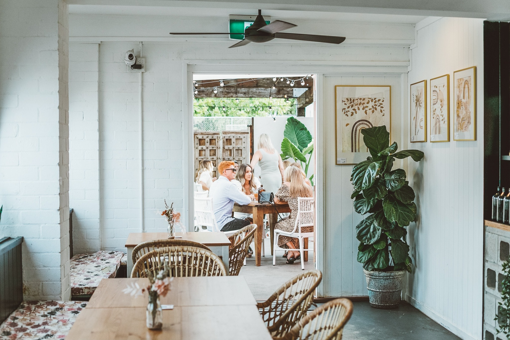 An inside view of the White Picket Fence cafe, showing tables and wall art