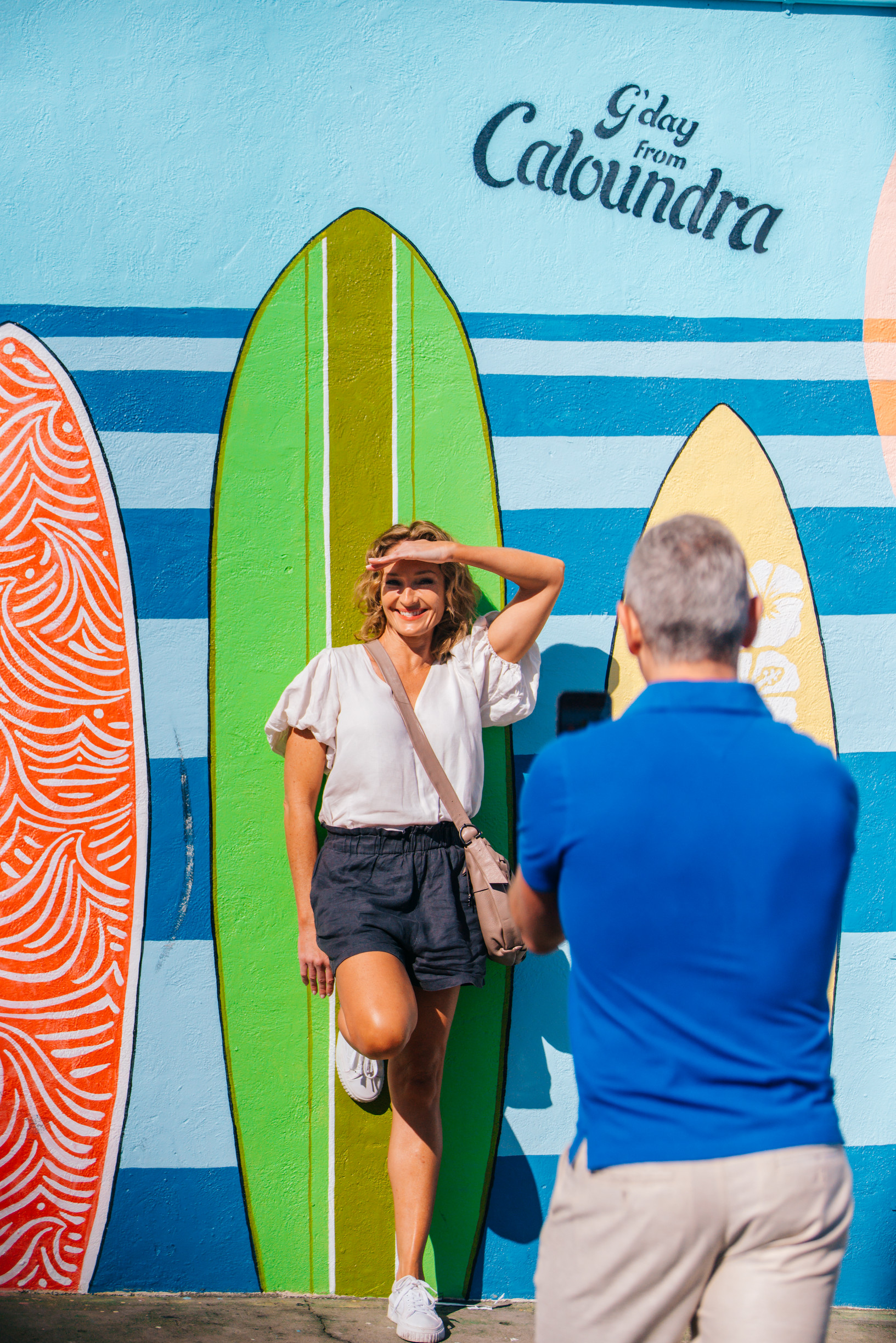 Couple taking a photo beside some street art in Caloundra Couple taking a photo beside some street art in Caloundra