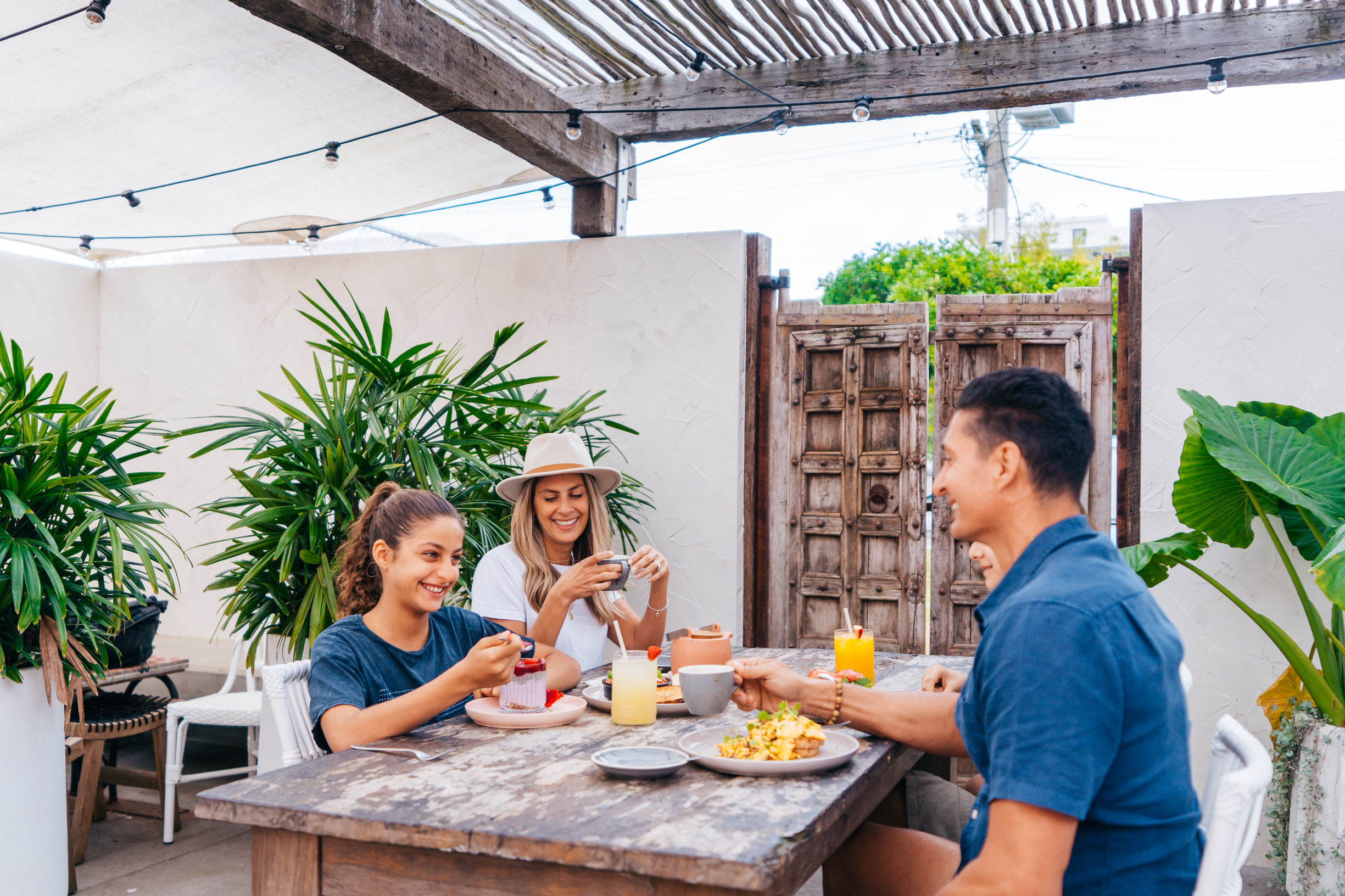Family enjoying a meal at White Picket Fence Cafe Caloundra | kid-friendly cafes restaurants Sunshine Coast