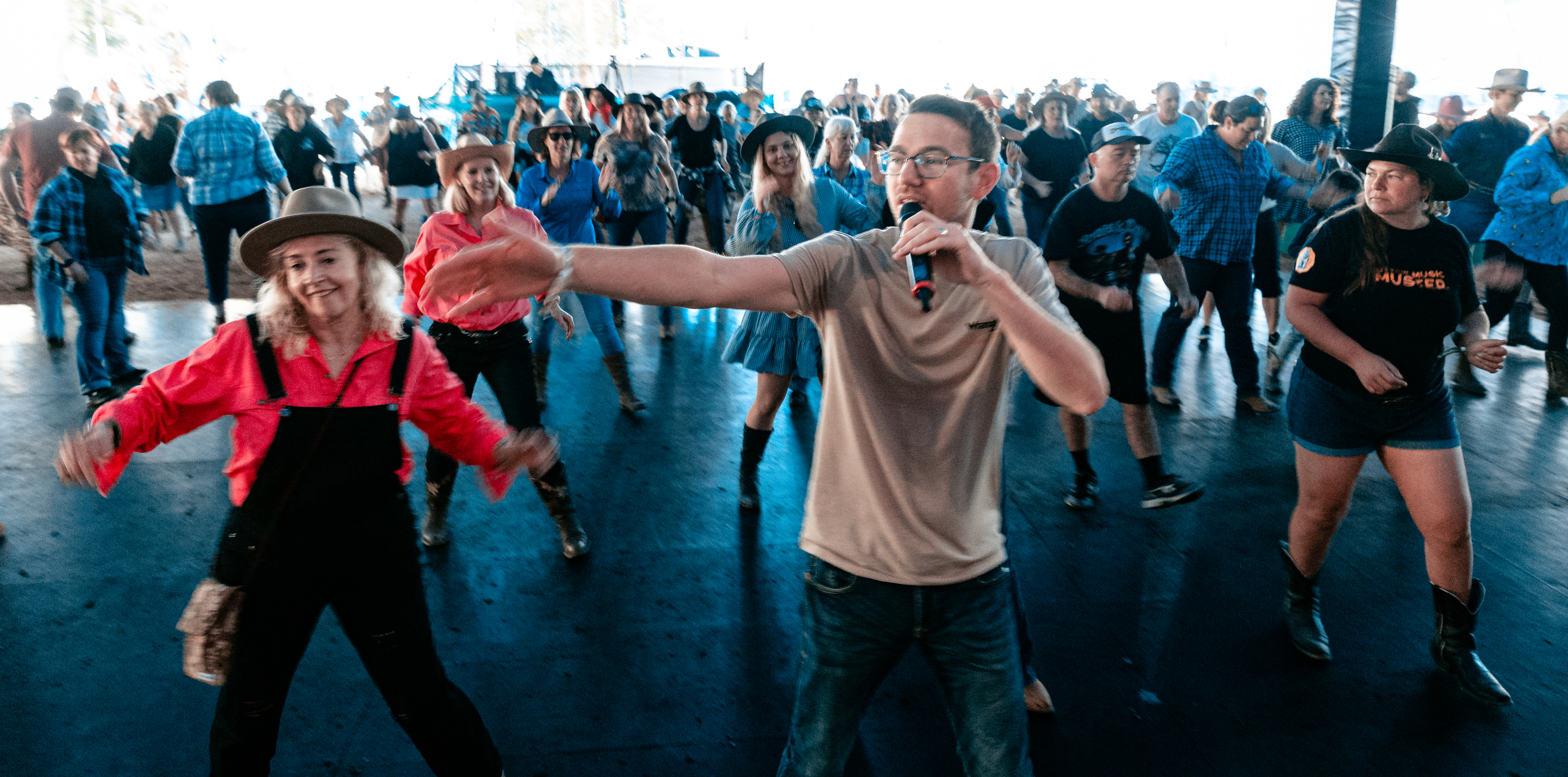 Festival goers taking part in a line dancing lesson at Gympie Music Muster