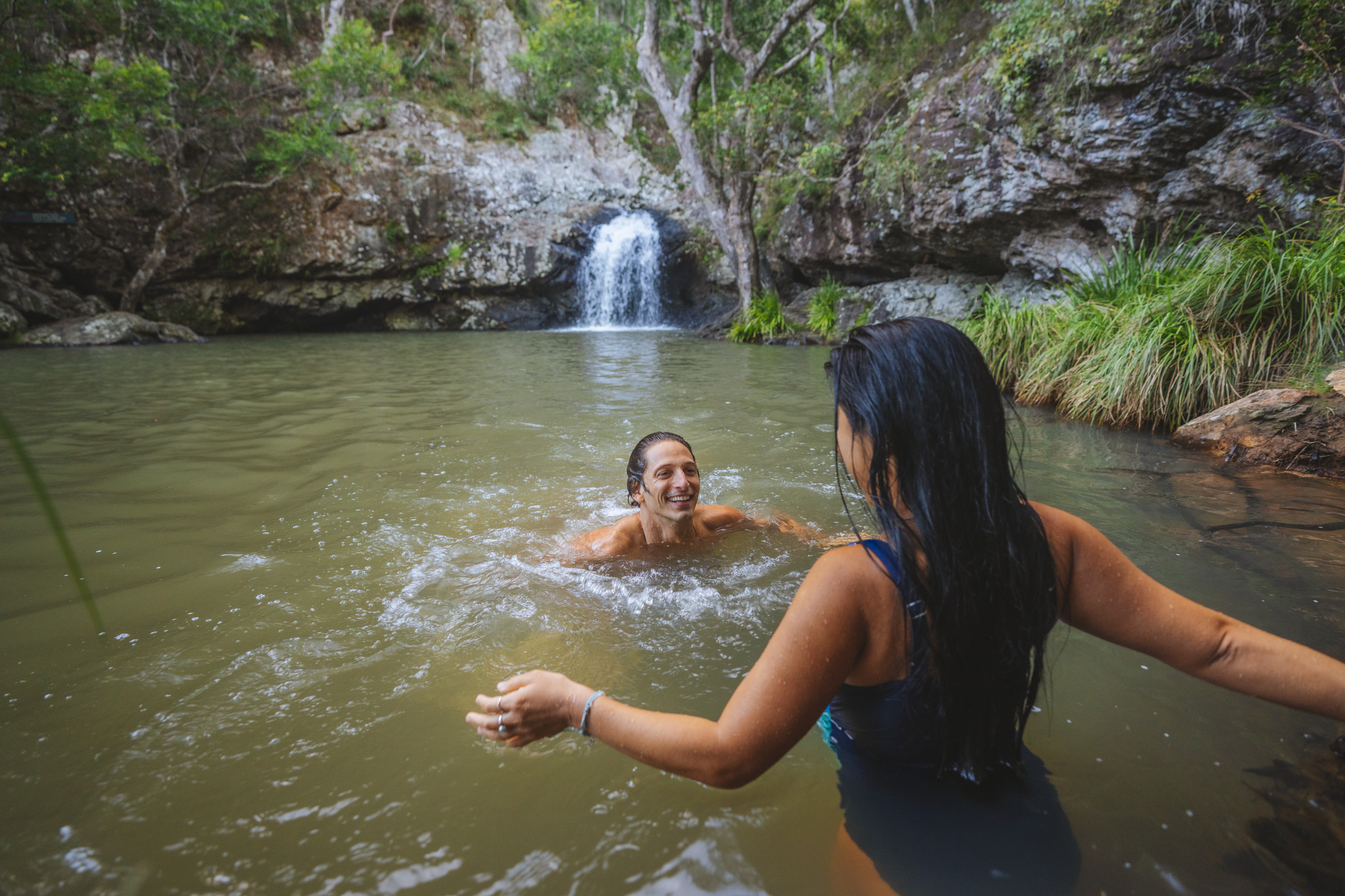 Couple having a swim in the rock pool at Kondalilla Falls