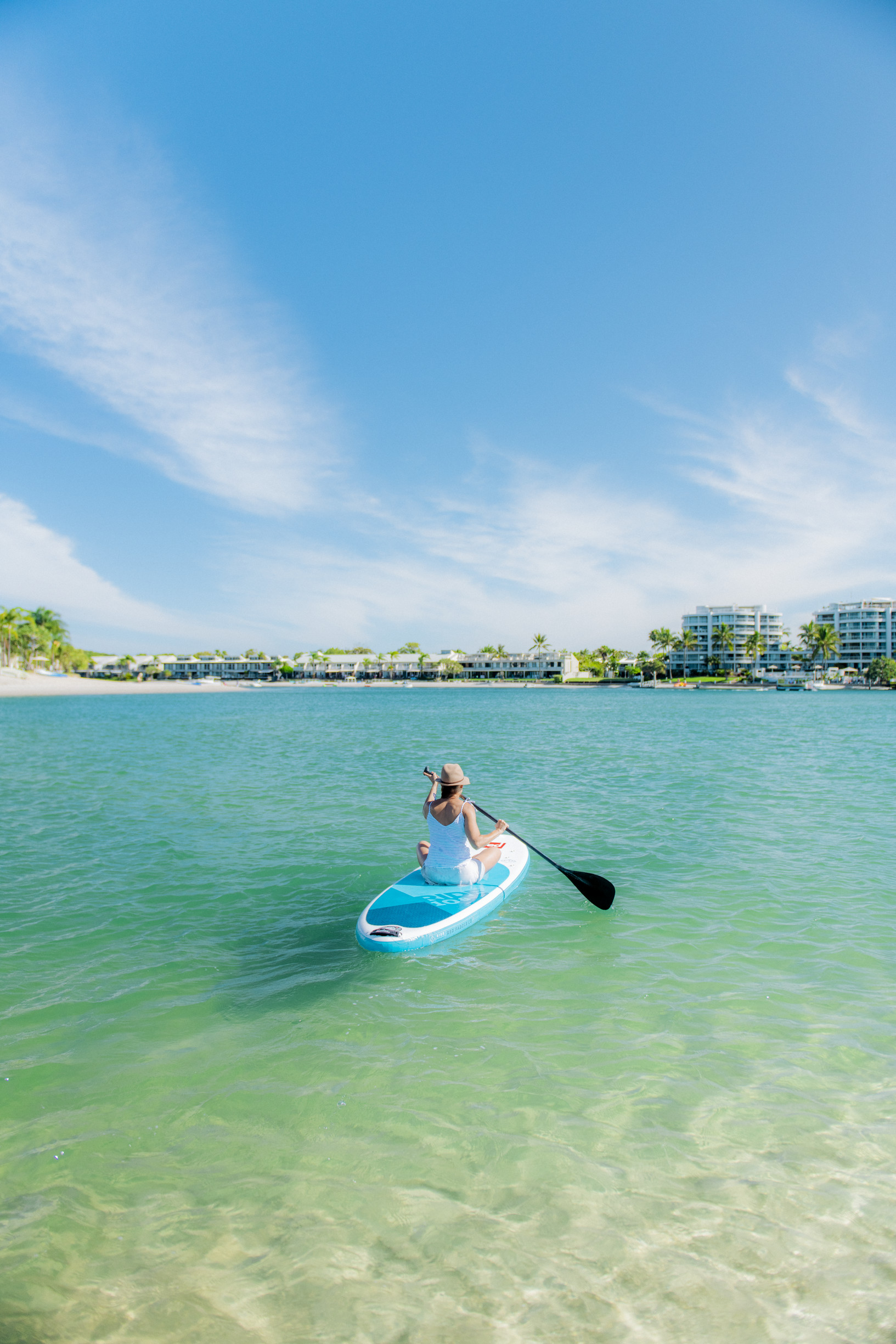 Lady paddling her SUP along the Noosa River