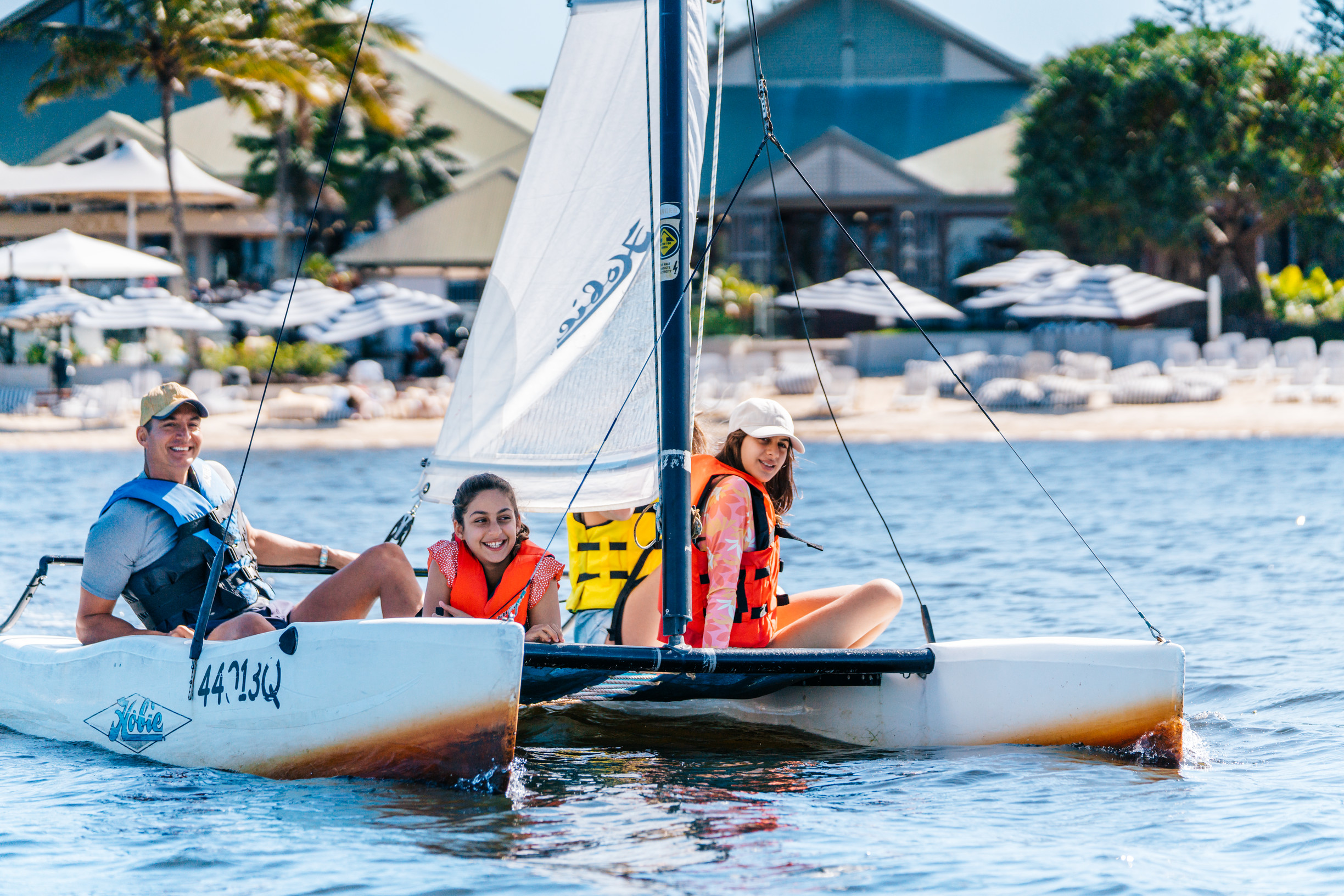 Family sailing their hire catamaran at Novotel Sunshine Coast Resort