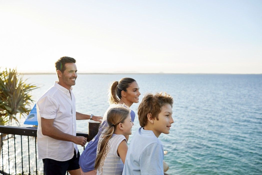 Family of four enjoying views of the ocean 