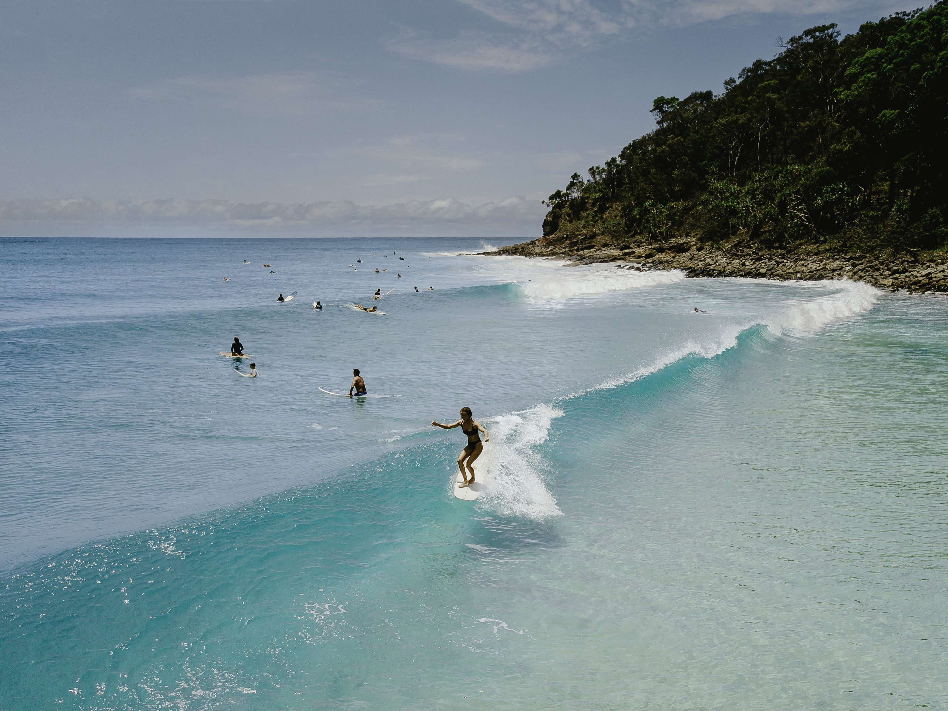 Surfer catching a wave in Noosa | Things to do in Noosa with kids Surfer catching a wave in Noosa | Things to do in Noosa with kids